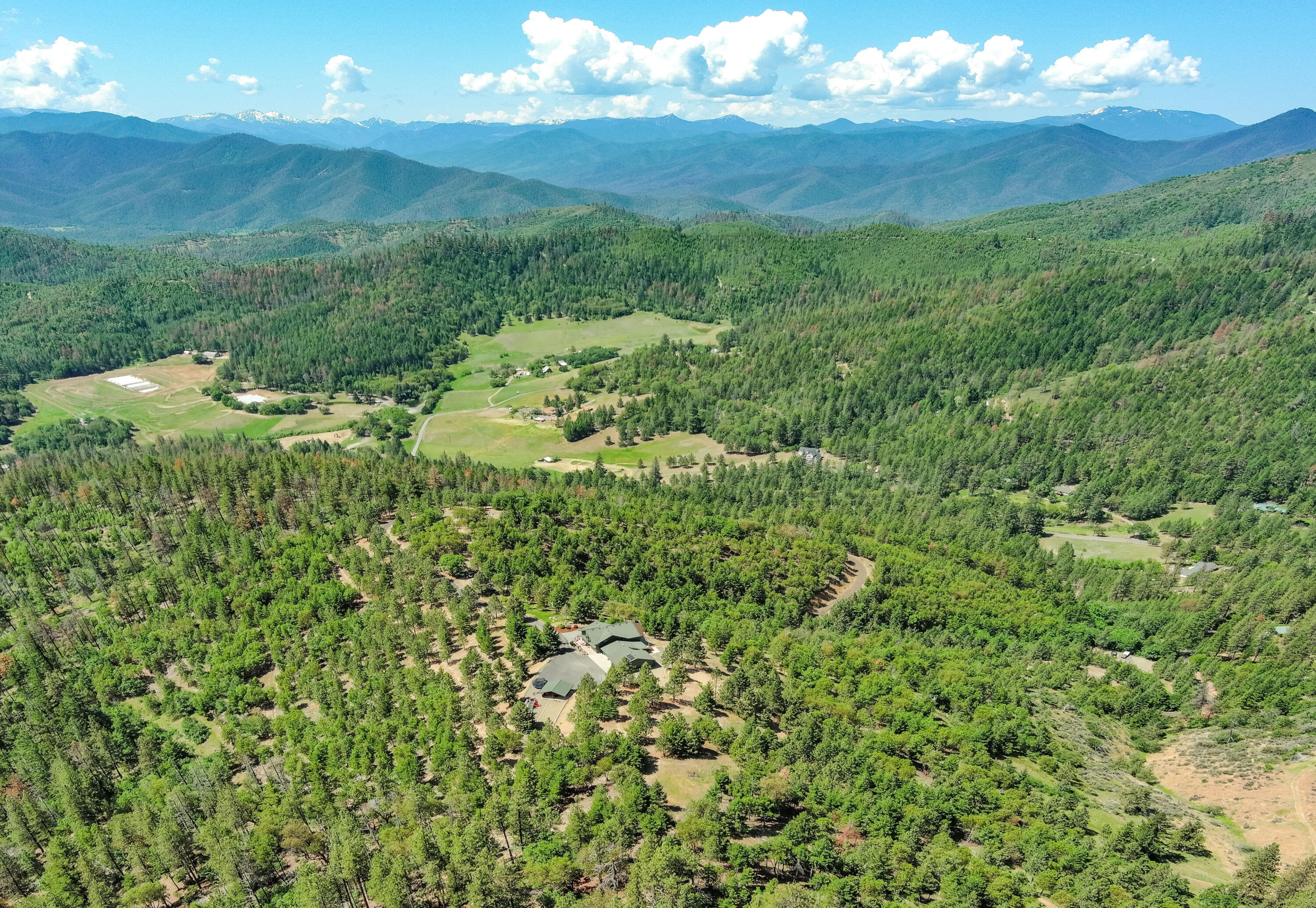 Private Mountain Top Retreat - Expansive & Forever Views. Relax & enjoy this magnificent & peaceful setting - it will surely warm your heart & energize your soul. Live a resort-like lifestyle on 40.77 scenic acres w/access to & adjoined on (3) sides by 777.5 acres of BLM land. The unique beauty of this property will be a reminder & inspire you to slow down, take a deep breath, & appreciate traditional values; Live/Love/Laugh. Enjoy nature less than 20 minutes to area shopping, fine dining, award-winning wineries, Jacksonville, or Medford. Every room with a view, this well-maintained 3,107' sqft, (4) bdrm., (3) bath home offers open spaces, vaulted ceilings, light/bright interior, & a full walkout daylight basement for guest/mother-in-law quarters w/private entrance & parking area. Over-sized fin. garage, +insulated/conditioned shop, lrg. pantry, inside/outside storage rooms., hot tub, expansive deck, paved driveway/parking near home, incredible pavilion/playground, & much more.