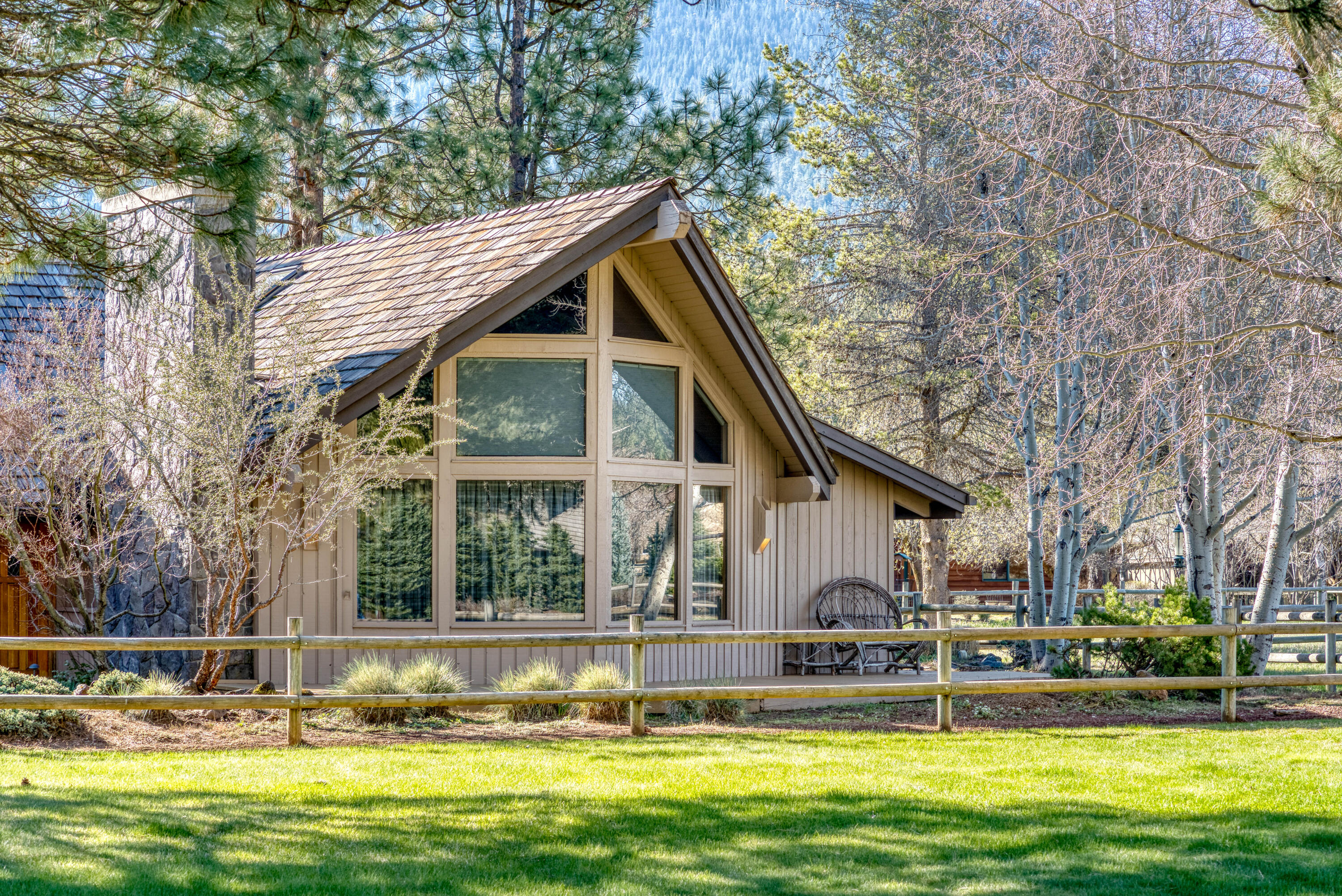 An Updated and Well Cared for Northwest Lodge Style home located in the heart of the beautiful Metolius River Basin. The open Great Room Floorplan features beamed ceilings, rustic wood paneling, stone fireplace, and an efficient kitchen w/granite countertops, cooking island, eating bar and adjacent dining nook.  There is a main level bedroom, bathroom, Den/office and a large laundry room. Upstairs are 2 separate primary bedrooms with ensuite bathrooms and many custom built-ins.  There is another indoor bonus room that can be a shop, hobby room, extra sleeping space or storage. The large attached double garage has a workbench and built-in storage w/ an airlock entry into the home. Enjoy the wrap around deck spaces for outdoor cooking/dining or a relaxing soak in the Hot Tub. Neighborhood amenities include seasonal swimming pool, tennis courts, trails, creekside common areas and direct access to US National Forest. Enjoy year-round recreation right out your front door!