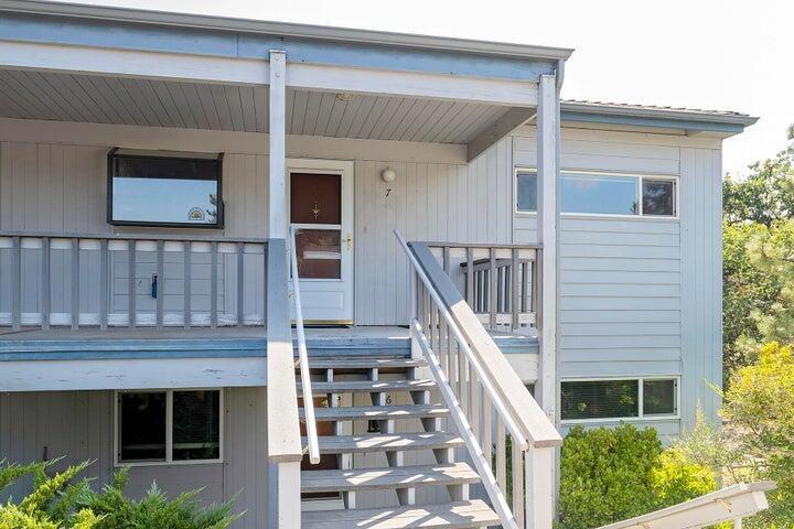 BEAUTIFUL LIGHT AND BRIGHT END UNIT with views of the golf course. Don't miss this opportunity! This 2-bedroom, 1-bath condo is located in the Oak Knolls neighborhood of Ashland. The kitchen is bright with plenty of cabinet space, a garden window and a pass-through to the dining room. The living room and primary bedroom open up onto a spacious, covered private outdoor patio. This unit boasts upgraded flooring with newer kitchen and laundry appliances. The bathroom features a large step-in shower and a bidet. This unit has a lot of storage space with 3 hall closets, a storage closet on the balcony and in the covered parking area, as well as large bedroom closets. You can enjoy the tranquil views of the community garden & backyard, and the beautiful Ashland hills from your living room or primary bedroom. The unit has updated plumbing, fresh paint inside & out and a newly repaved parking lot with carport! One Seller has active Real Estate License in the State of Oregon