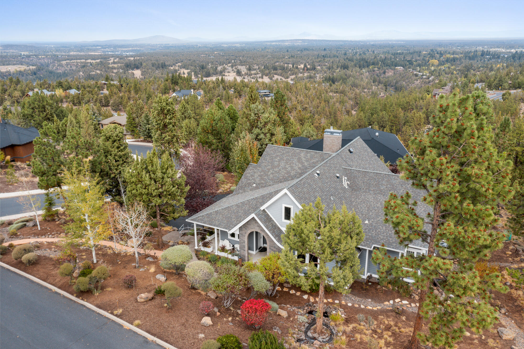 Absolutely perfect to work from home. This stunning Bend residence w/panoramic views offers the ultimate dedicated office space plus an additional flex room for second work area. High quality Milgard windows frame views of the Cascade range, Ochocos, Smith Rocks and more. Home has been meticulously maintained. Hardie plank siding, high level composition roof, epoxy coated 3 car garage , freshly sealed flat driveway and current home inspection make it move in ready. Primary suite w/ his, hers closets, fireplace & deck access. 2 en suite additional bedrooms plus guest area off flex room. Gourmet kitchen w/ textured granite countertops & island opens to great room & decks for easy entertaining. Water feature greets you at the unique arched front door. Northwest slate flooring throughout entry & great room plus floor to ceiling stone fireplace create a welcoming northwest feel. Extra storage throughout garage including 2 work spaces and extra pantry area.