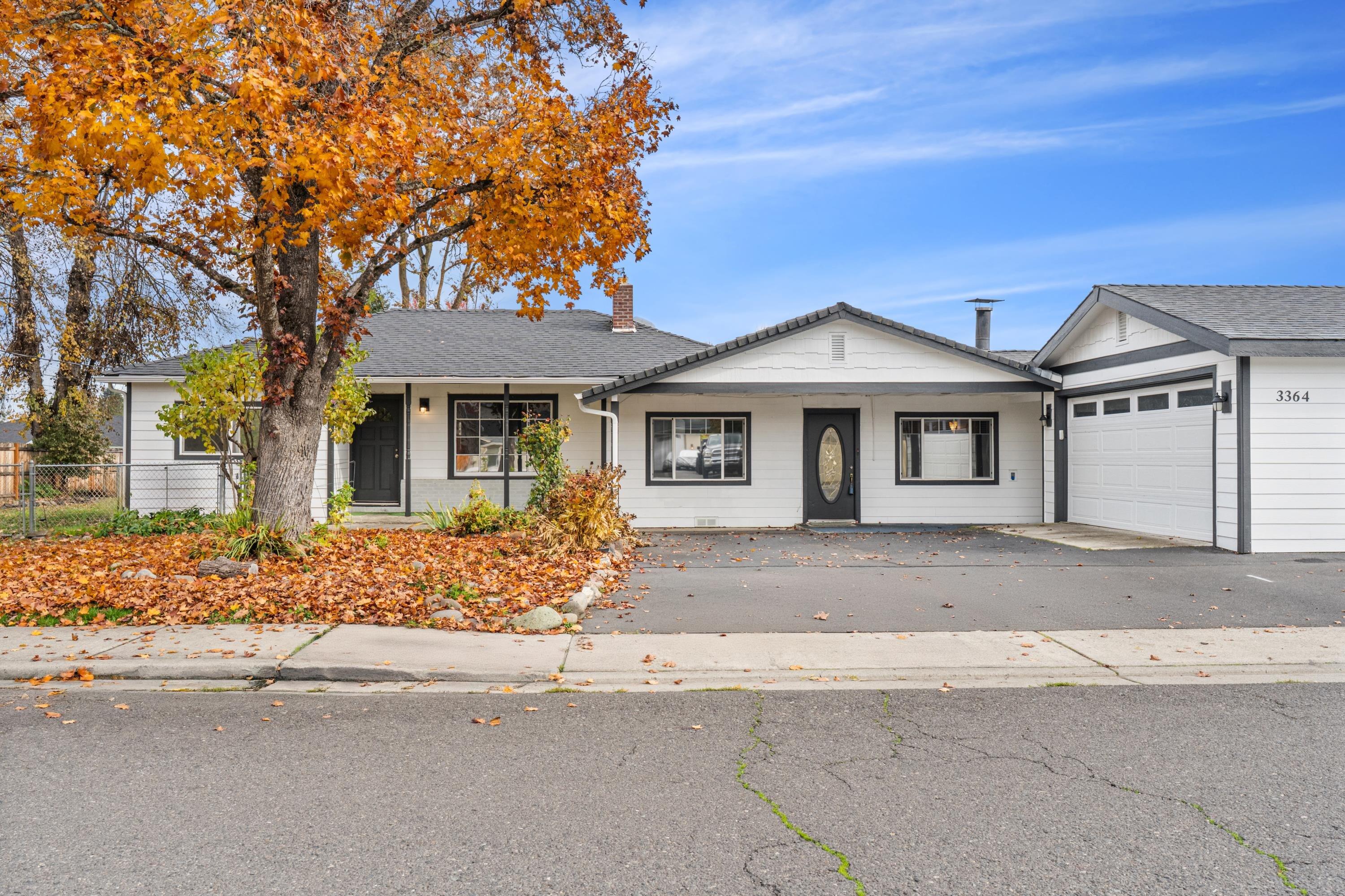 Ideal Two-Family or Multi-Generational Home! This spacious 4-bedroom, 3-bath Central Point home offers the perfect blend of togetherness and privacy. Designed with flexibility in mind, it features two separate living areas each with its own entry. One side includes a kitchenette, oversized bedroom, walk-in closet, full bath, and private living space, making it ideal for extended family, guests, or even rental income. The main living area offers an open floor plan, updated finishes, and access to a large fenced yard perfect for gatherings or gardening. With a newer roof, fresh exterior paint, and a 2-car garage, this home is truly move-in ready. Connected only by a shared utility room, it gives everyone space to live comfortably while staying close. A rare gem to find offering versatility, value, and peace of mind!