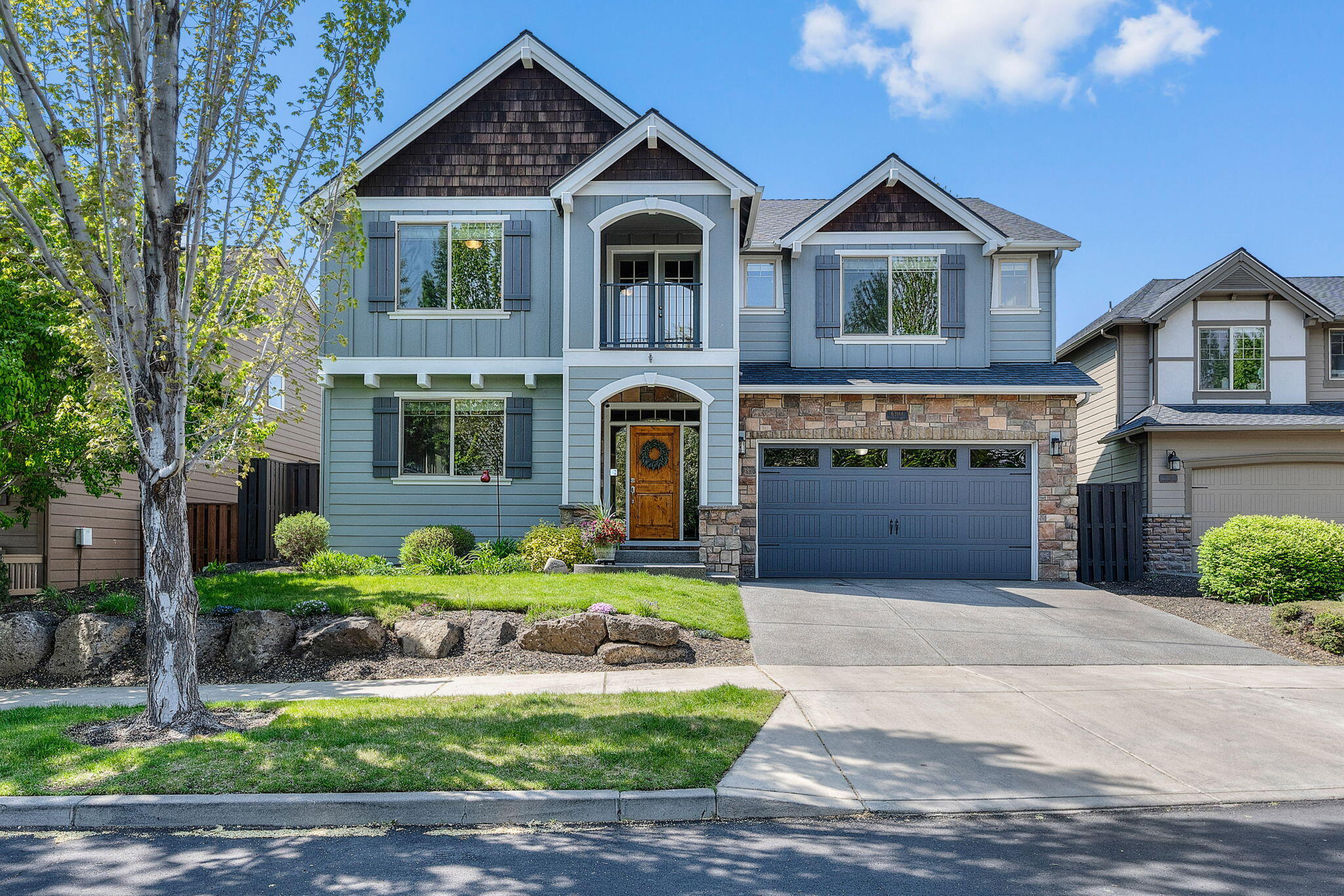 Set on the western edge of Lava Ridges and backing to the canal, this 5-bedroom home with a bonus room offers space, flexibility, and unbeatable outdoor access. Enjoy the soothing sounds of water from your fully fenced backyard with direct trail access and a private hot tub. Inside, hickory hardwood floors, an open-concept layout, and a bright, spacious kitchen with breakfast bar create a warm and inviting atmosphere. A main-level bedroom and full bath add functionality, while the 3-car tandem garage provides ample storage. Located in one of NE Bend's most sought-after neighborhoods, residents enjoy a community pool, front yard maintenance, and close proximity to Pine Nursery Park, Lava Ridge Elementary, and Cascade Village shopping. This home is ideal for those seeking both adventure and comfort in Central Oregon.