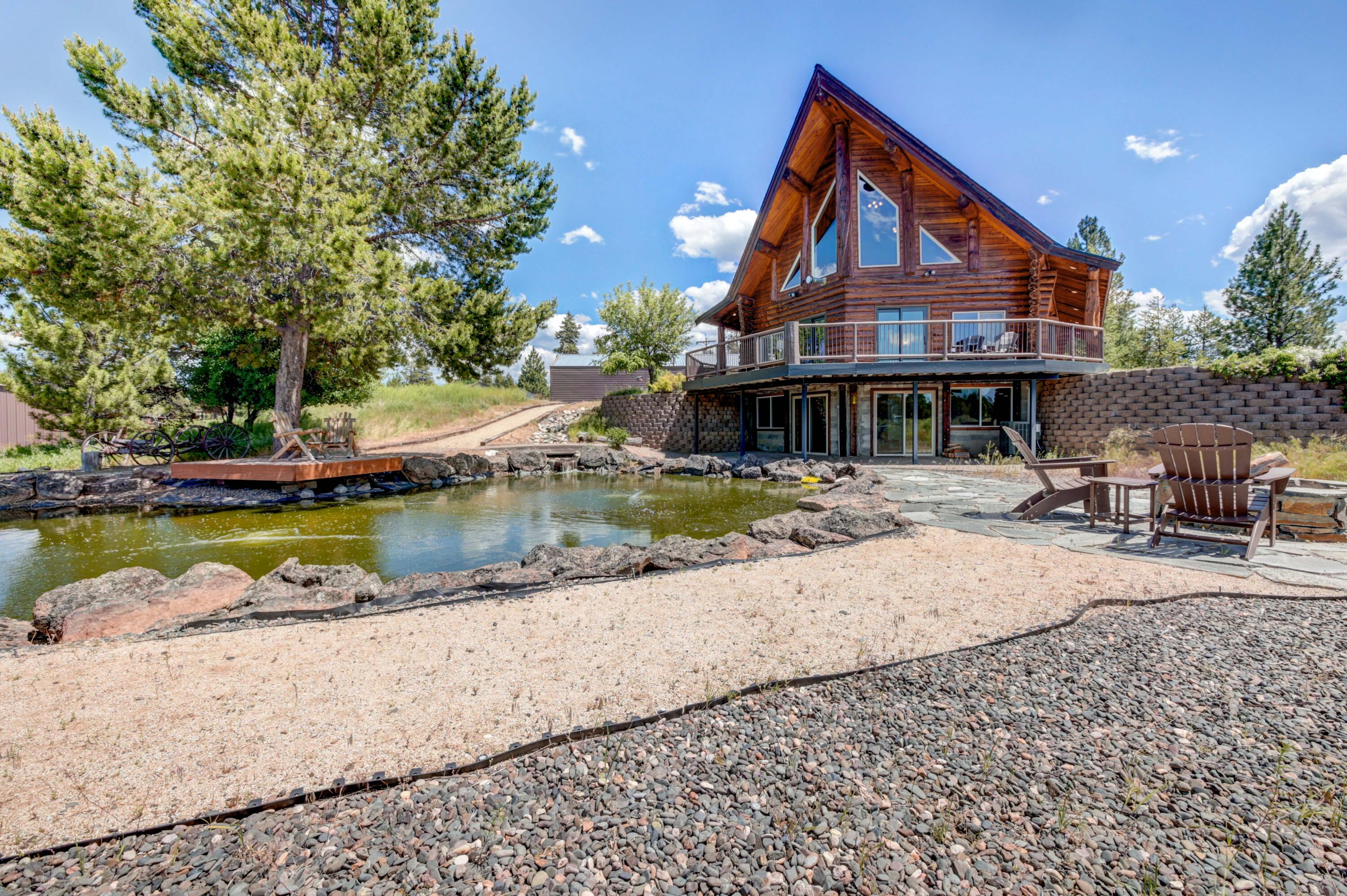 Truly remarkable custom built log cabin on the Little Deschutes River with expansive views of river valley,  Mount Bachelor, Broken Top, and the Sisters. Walking through the front double doors into the great room you're amazed by log expanses, brilliant wood work, and floor to ceiling windows to view the wildlife, mountains, and river.The cabin has a large loft, 3 bedrooms, and 2 bathrooms. The lower level has a second large living room/game room that looks over your private pond up to the mountains. Beautifully landscaped with aspens, pines, a pond, and a fire pit. Imagine catching rainbow trout as you watch elk stop for water then enjoying dinner on the deck while the sun sets on the Cascades and valley. This is your private paradise...enjoy it! Just minutes to Cascade Lakes, skiing, Bend, Sunriver, and endless recreation.Has garage and covered parking.  This is your chance to own 9.66 acres of riverfront paradise.