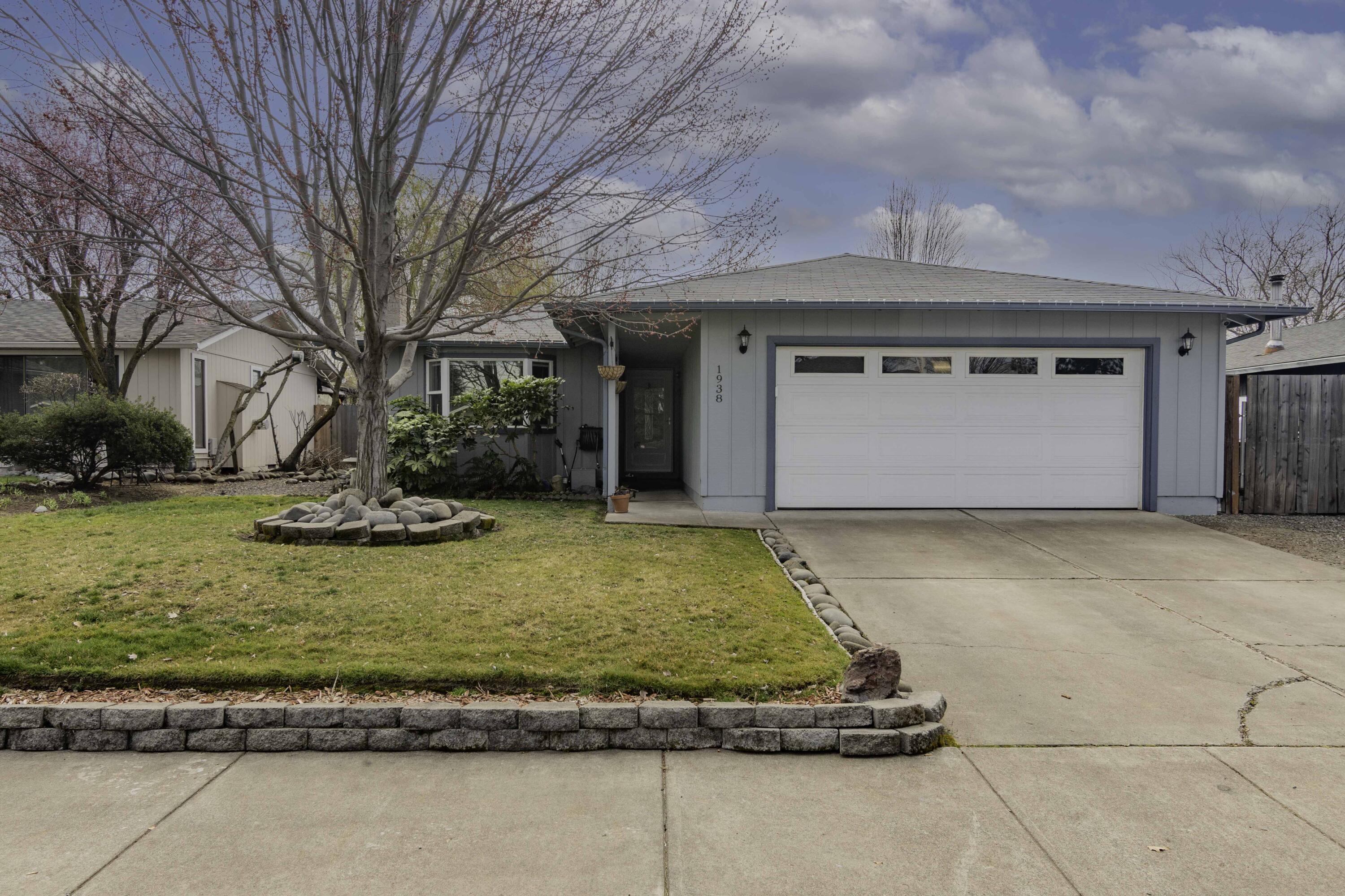 Captivating and Charming Home in Medford! Nestled on a picturesque 7,405sqft lot in a highly desirable area, this 3BR/2BA, 1,436sqft residence welcomes with mature landscaping, beautiful vernacular architecture, and a covered entrance. Step inside the luminous interior to discover wood flooring, an openly flowing floorplan, tons of natural light, a sizeable living room, and a fully-equipped kitchen featuring black stainless-steel appliances, white cabinetry, and solid surface countertops. Designed for easy entertaining, the fully fenced and private backyard includes a sprawling concrete patio, a huge greenspace, lush greenery, gorgeous hardscaping, and plenty of room for grilling and chilling. Unwind and lounge in the primary bedroom, which has tons of closet space and an attached en suite. Two additional bedrooms are generously sized with dedicated closets. Other features: 2-car garage, laundry area, shed, near shops, restaurants, I-5, Starbucks, and schools, and more! Come See Today!