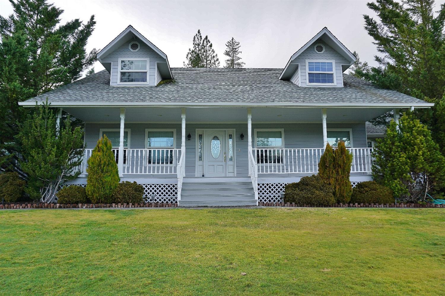 The front porch has views for miles.This wonderful country farmhouse was custom built by the current owners and has been lovingly cared for since. With over 3880 square feet and 4 bedrooms, 3 baths the floorplan works nicely for a small family, large family or just the two of you! The home itself sits almost in the middle of the 15+ acres with 2-3 acres of flat usable land for gardens or an arena. Master is on the main level and the kitchen will WOW the best of cooks. Dog run and RV parking as well as a large storage building complete the picture! This property is priced to sell so don't wait to take a look! All information is deemed reliable but not verified; anyone considering purchasing this property should perform their own investigation into the uses and condition of the property.
