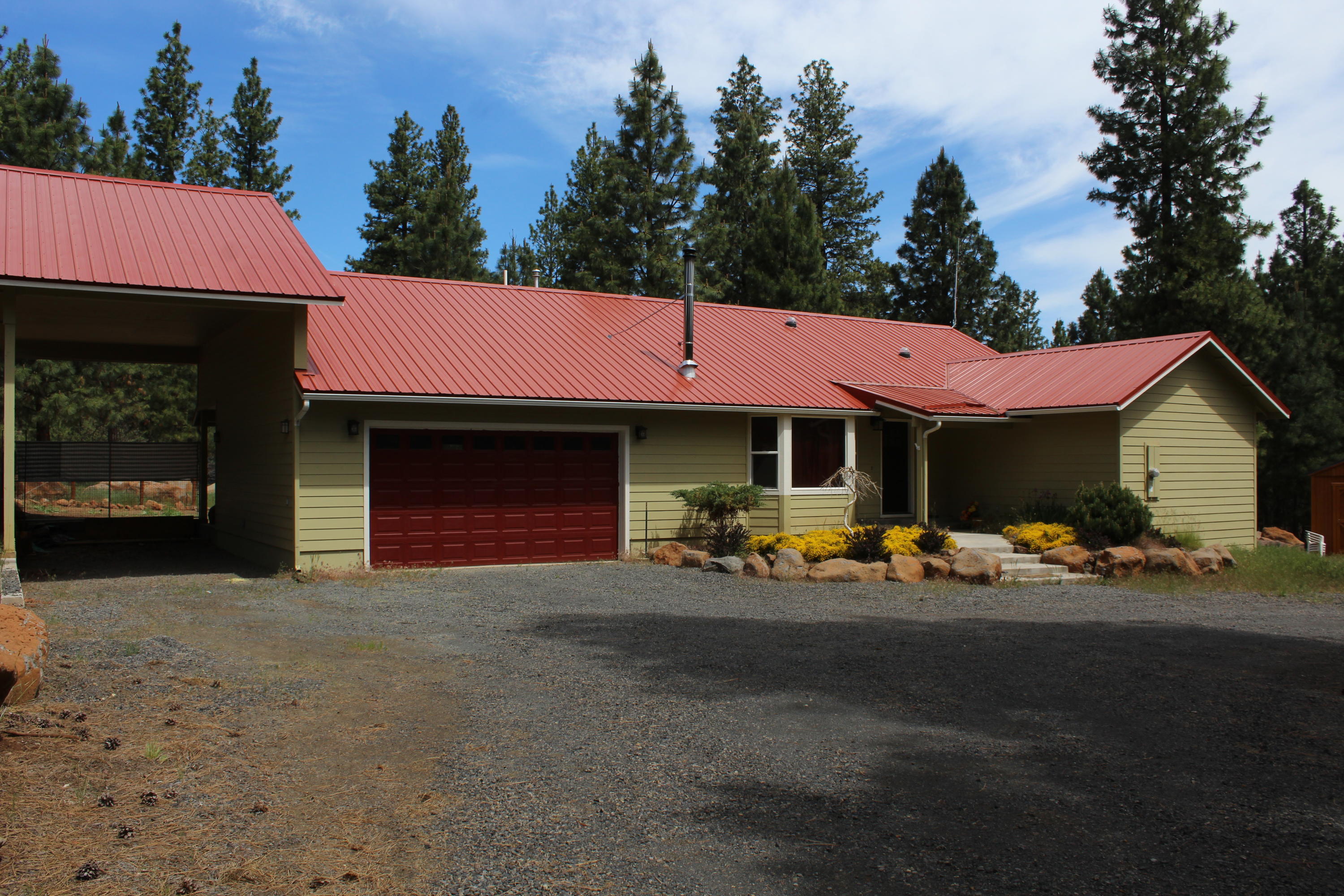 Enjoy the rustic feeling of this custom built home on 5 acres in Keno. Home has an open floorplan with 3 bedrooms, 2 baths, a beautiful kitchen with large island, granite tiled counters and Stainless appliances. Washer and Dryer are included. Master Bath has travertine tile, a sunken jacuzzi tub and large walkin closet. This home is heated with propane F/A heat and has a certified wood stove. You can enjoy relaxing on the covered patio or around the propane fire pit. Property has a large circular drive, heated dog house/kennel in the barn, a brand new Tuff Shed and is surrounded by beautiful Pine Trees.