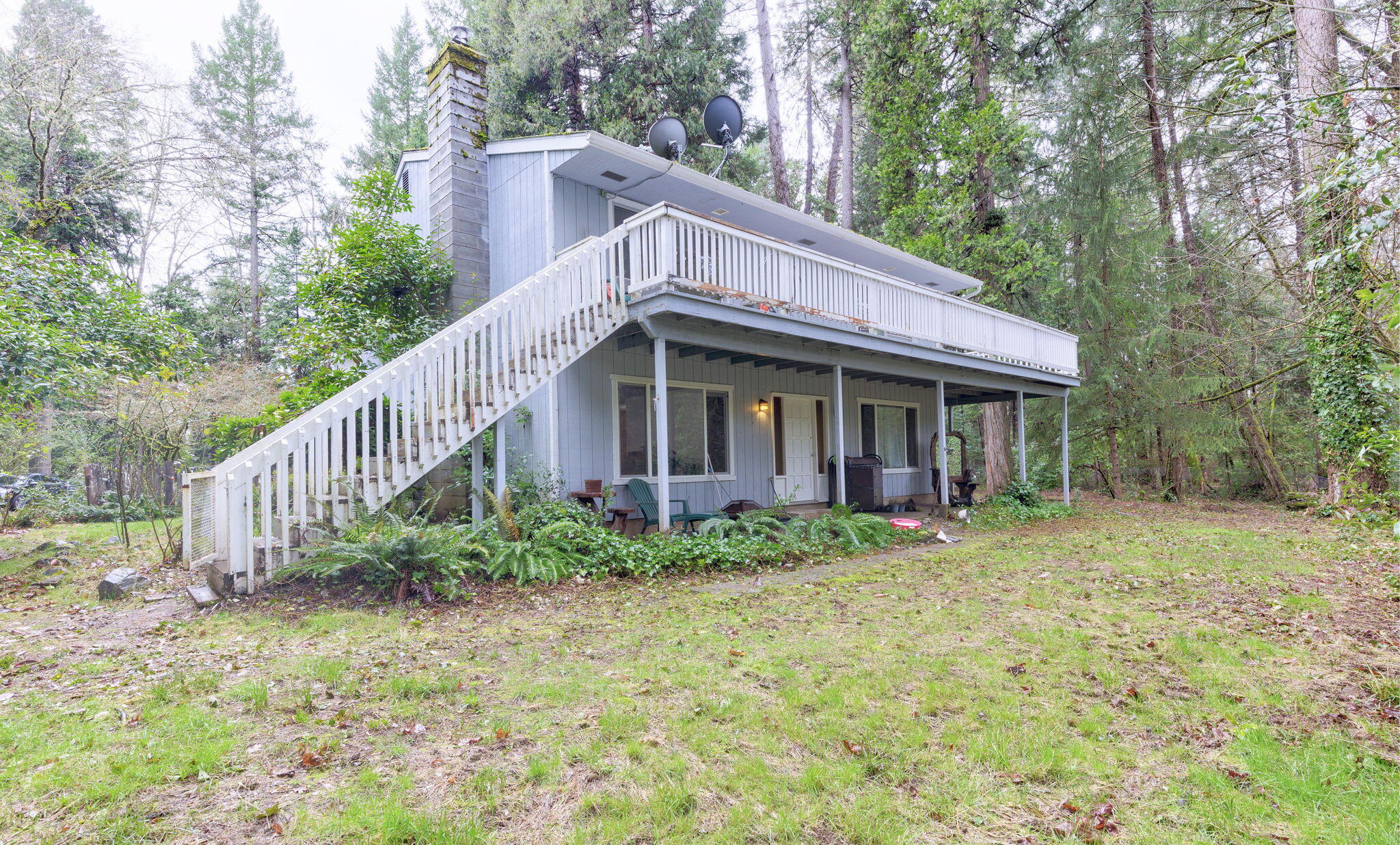Wonderful Setting among majestic trees on this waterfront property!  Head down to the year-round creek and enjoy your own private piece of nature. Gated entry leads to the house which was built in 1976 but has had some recent upgrades, including new flooring throughout. Sitting on 5.08 acres the home features 3 bedrooms, 2 bathrooms, approx. 2016 sqft., nice kitchen on the upstairs level, with refrigerator, DW, R/O, and dining area with slider to wrap around deck.  Large living room off kitchen with slider to the deck. Also, on the upstairs level there is a bedroom with slider to the deck and a den/office which could be 4th bedroom.  On the ground level hosts a family room w/fireplace that has a woodstove insert, 2 bedrooms, a bathroom and laundry room.  Patios out front & back of the house and a detached 2 car garage with attached carport.  Relax in your meditation hut tucked away in the garden.  Fenced garden area.   Enjoy picking your own apples, pears, grapes, and blackberries.