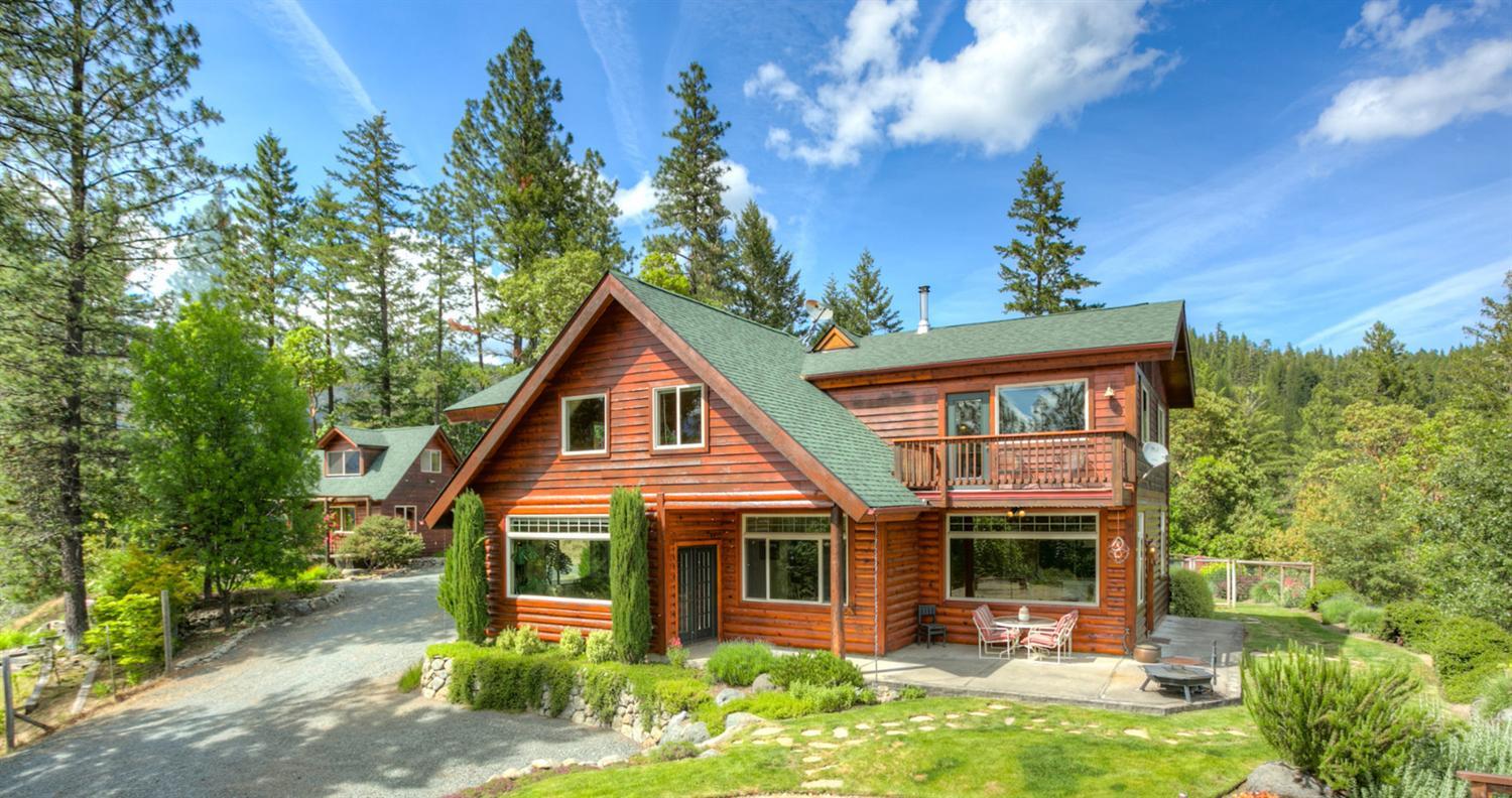 This high end, custom built home is secluded & situated facing south on a 5 acre beautiful hilltop lot with incredible ~ 360 degree views including Greyback Mountain, the Williams Valley, Red Buttes Wilderness & the surrounding Siskiyou Mountains! So many living options here! This home offers 4 bedrooms & 3 bathrooms, including 2 master suites, large office or potential 5th bedroom w/ separate entrance & additional 740 Sq Ft in-law cottage w/ full bath. There's more, a 484 Sq Ft heated shop w/ water& 220 volt service & a 700 Sq Ft 2 car garage! This prime Williams location offers miles of hiking, biking & riding trails right outside the front door. The yard has mature landscaping mixed w/ native wildflowers, Madrone, Cedar, Oak, Fir & Pine. It has a fenced, irrigated & landscaped gardening area, as well as a 16 ft x 32 ft oval above ground swimming pool (3' to 7' deep) surrounded by a cedar deck. A new well pump was installed in 2015 & the main house & cottage had new roofs in 2014.