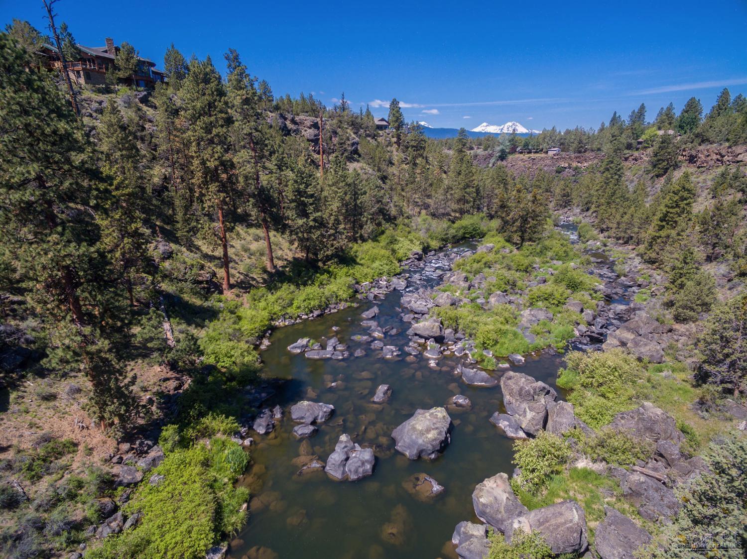 Privacy on the Deschutes River in this stunning remodeled home in Bend. Designed around gorgeous full on river views. Extensive attention to detail. High end appliances, wood /tile flooring,wood wrapped windows, duel fireplace, prepped for elevator. Master suite w/additional fireplace & those river views. His/hers walk in closets. 2 office spaces, lrg triple garage. Private end of the road location w/land that rolls to the river. Fish, walk to town.