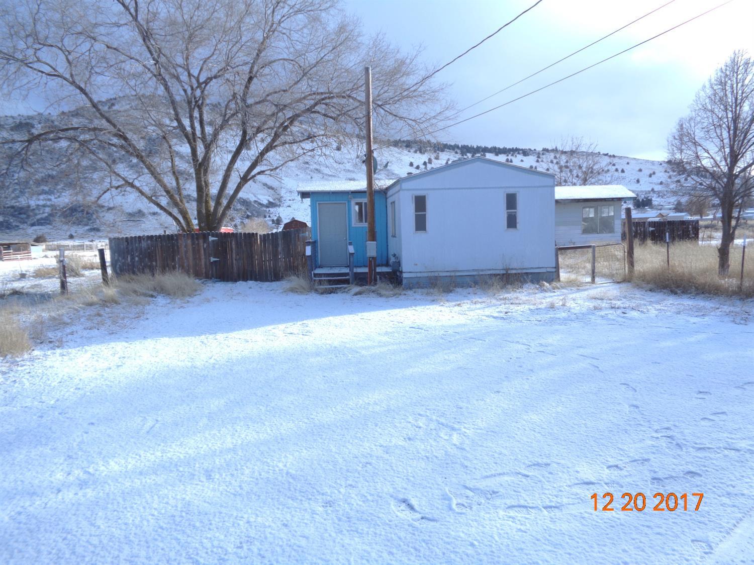 Manufactured home on a large 1 acre lot on the north side of town. Room for animals. New septic tank. There is also a small barn and another structure that has electricity, no water or heat and has been used as a guest quarters.