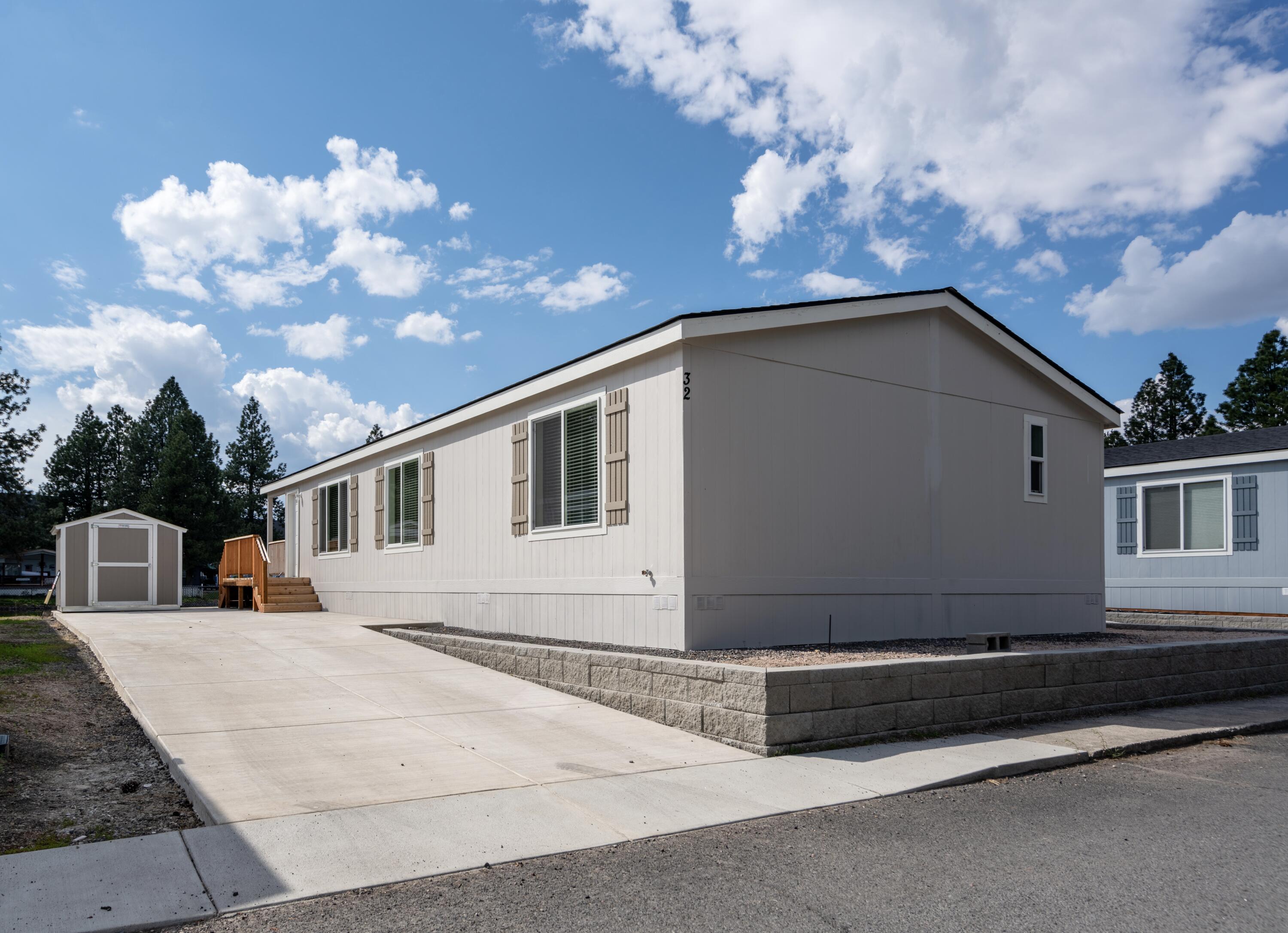 Introducing a brand new, beautifully crafted manufactured home nestled in the tranquil neighborhood of The Pines in Southeast Bend. Step inside to discover a modern and stylish interior, designed to maximize both functionality and aesthetics. The open floor plan seamlessly connects the living, dining, and kitchen areas, creating a welcoming atmosphere for gatherings and everyday relaxation. This spacious residence boasts 3 bedrooms and 2 baths spread across 1,358 square feet, providing ample space for comfortable living. The well-appointed kitchen features stainless steel appliances and abundant cabinet space. The large covered deck, overlooking the adjacent pond, provides a serene backdrop for outdoor gatherings or peaceful moments of solitude. Amenities include snow / yard debris removal, clubhouse access and a playground with a basketball court. Carport and landscaping to be completed. Schedule your showing today!