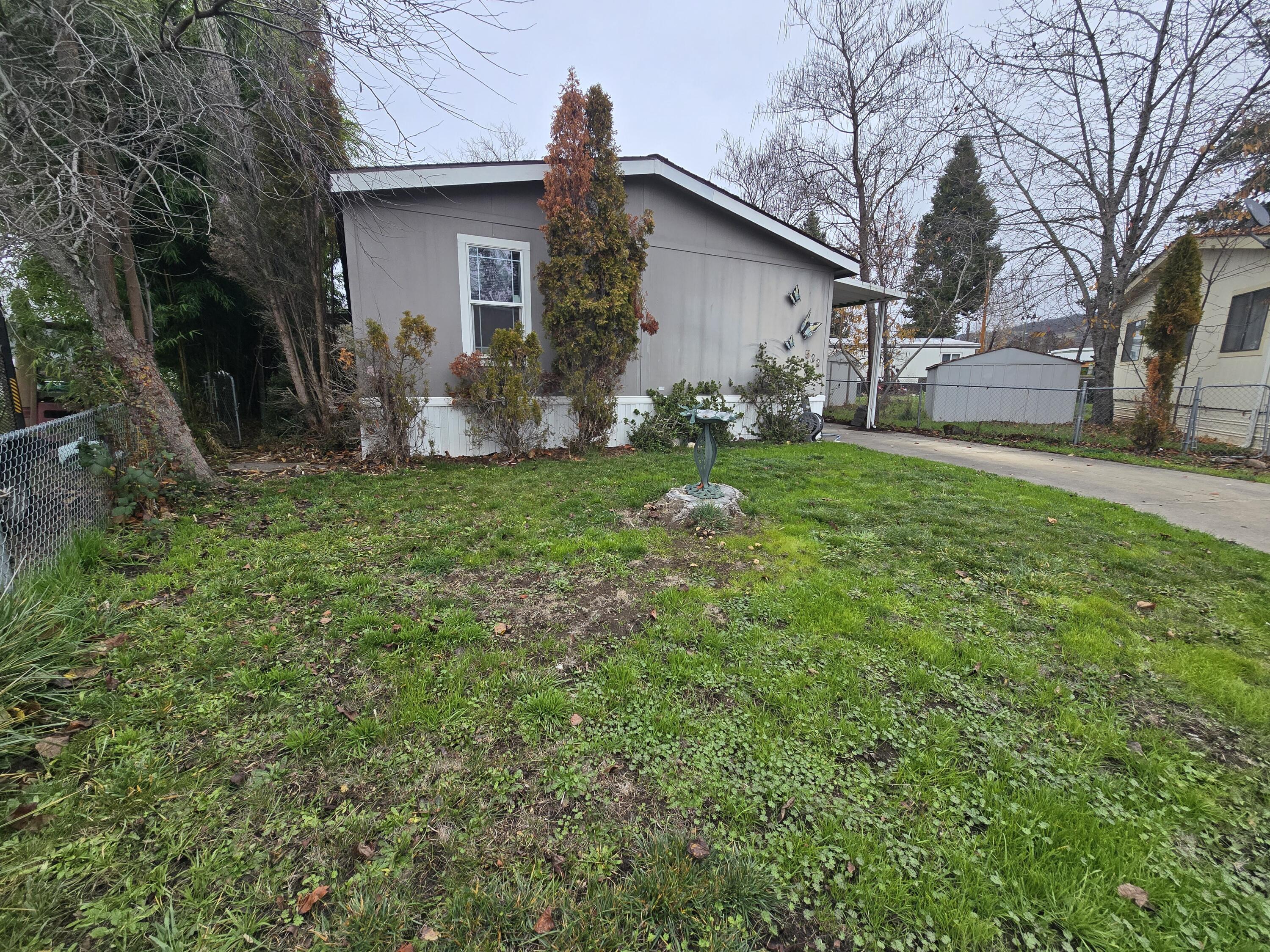 *THIS HOME IS SITUATED ON ITS OWN LAND* Welcome home! This charming 3-bedroom, 2-bath residence offers 1,512 sq ft of comfortable living and sits on its own .11-acre lot in the heart of Eagle Point. Enjoy the convenience of being close to shopping, schools, and dining while still tucked away in a peaceful neighborhood. The open layout and expansive vaulted ceilings create a bright, airy feel throughout. The kitchen offers abundant cabinetry and storage, perfect for all your cooking essentials. Relax in the spacious primary suit featuring a garden tub for soaking after a long day. A separate laundry room provides added functionality and leads out to the back porch—ideal for enjoying your morning coffee or unwinding in the evenings. This home truly combines comfort, convenience, and charm in one great package!
