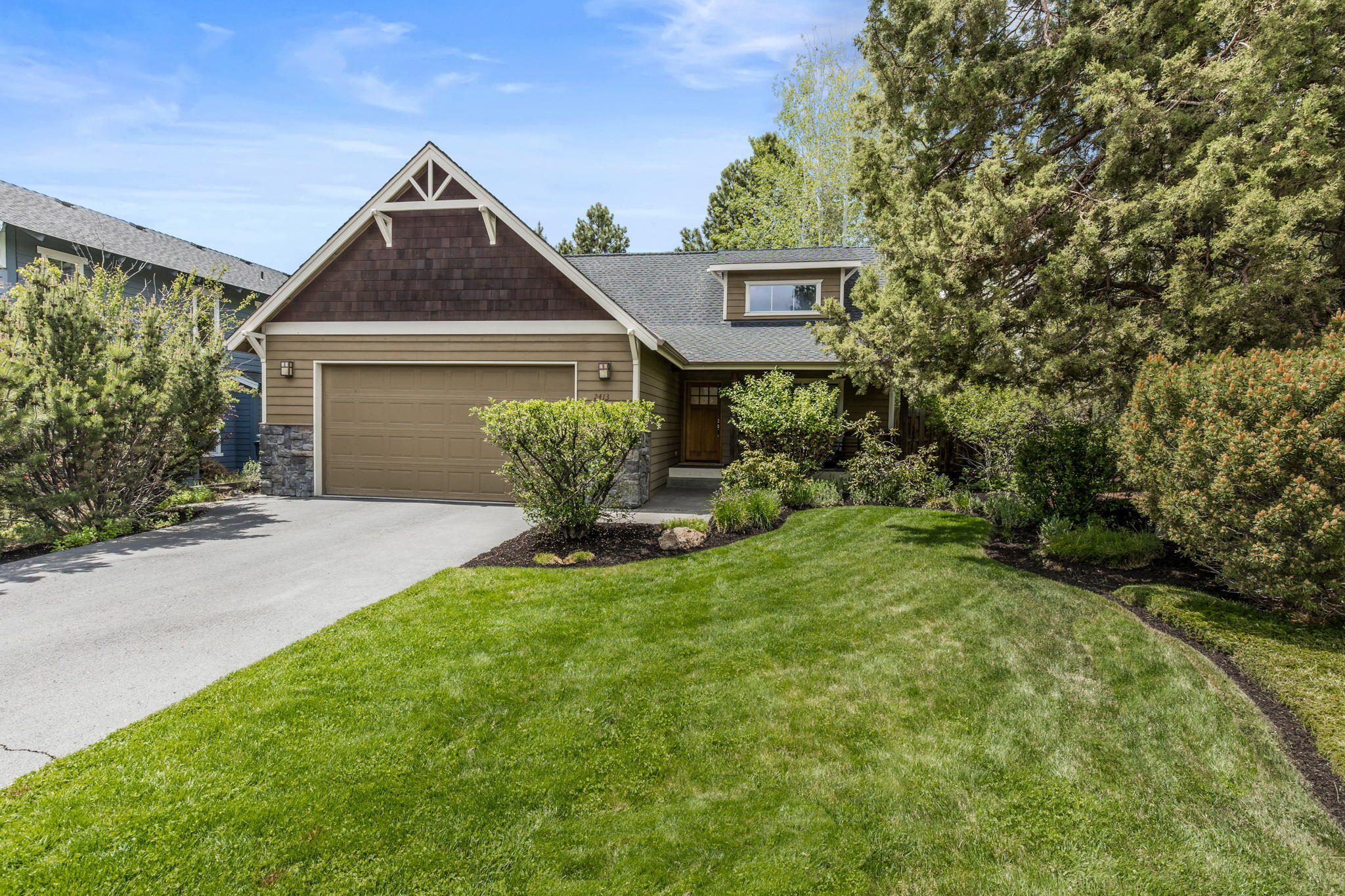 This charming home is located on a quiet street in the Hawks Ridge neighborhood offering a prime location on Bend's Westside with easy access to Downtown. The attractive covered front porch welcomes you into a well designed great room with soaring ceilings, gas fireplace and lots of windows for natural light. Wide plank hardwood flooring flows through to the dining area and kitchen with tiled counters and ample cabinetry. Large Primary Suite on the main level, two additional bedrooms and full bath upstairs w/extra storage space. The large and level lot is beautifully landscaped with mature trees and offers a very private, fenced backyard perfect for entertaining with both a deck with pergola and a paver stone patio with fire pit. Double car garage, A/C and move-in ready!