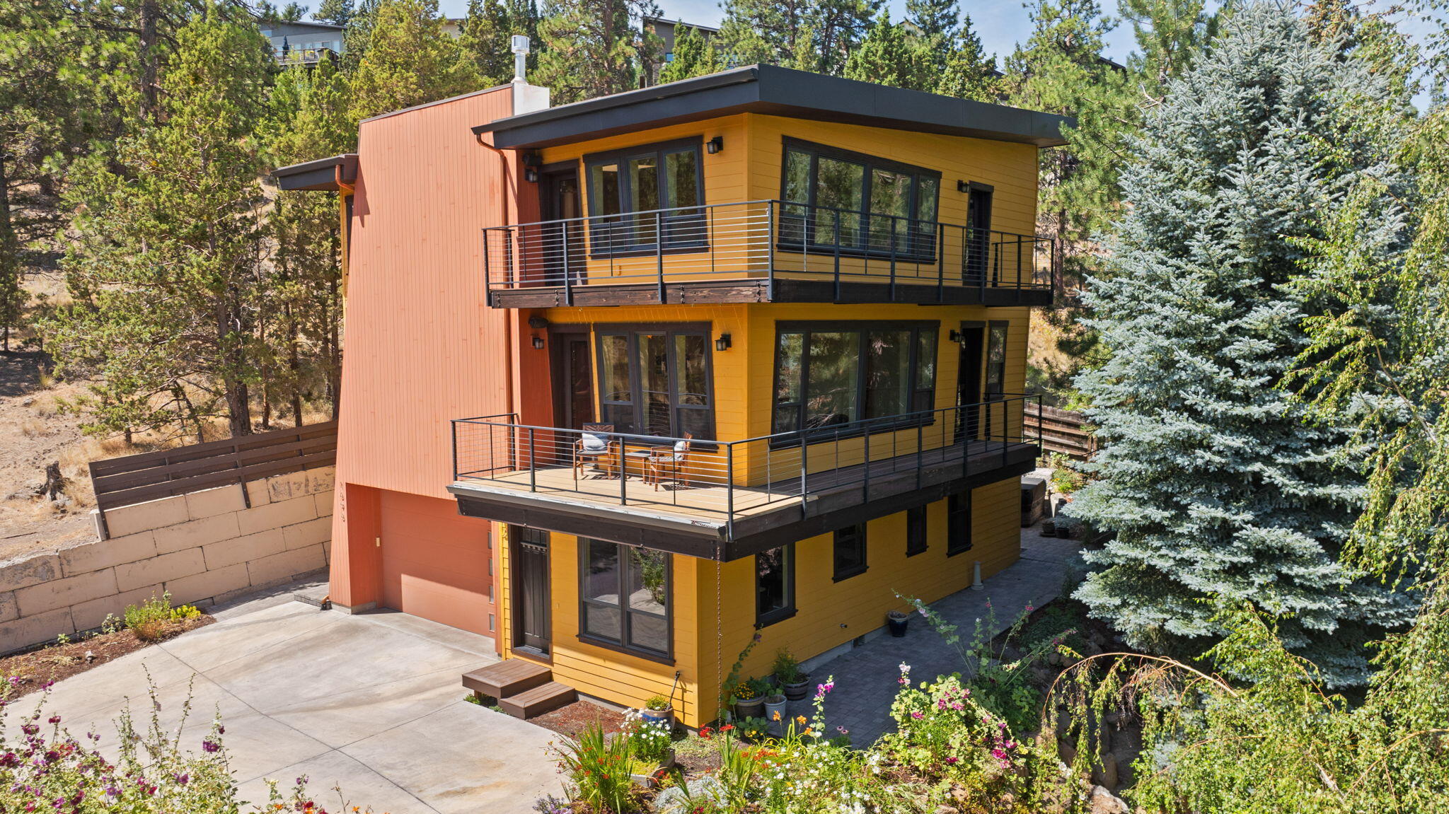 Welcome to one of the most distinctive homes on the market — a builder's masterpiece, where energy efficiency meets inspired design in one of Bend's most coveted neighborhoods. Architecturally Stunning, Energy-Efficient, and Income-Generating!  This stunning custom-built residence by Alcove Homes features 4 beds and 2.5 baths in the main house, plus a full 1-bedroom, 1-bath ADU, totaling 2,750 sq. ft. of luxurious living space. The main level primary boasts a tile bath with heated floors. An open floor plan showcases high ceilings, custom woodworking, and granite countertops. Wrap-around decks with breathtaking views and a hot tub on your private patio, a low-maintenance yard, all with a treehouse feel. This Earth Advantage, platinum-certified home in SW Bend has easy access to restaurants, retail, and Mt Bachelor. Don't miss this unique opportunity!