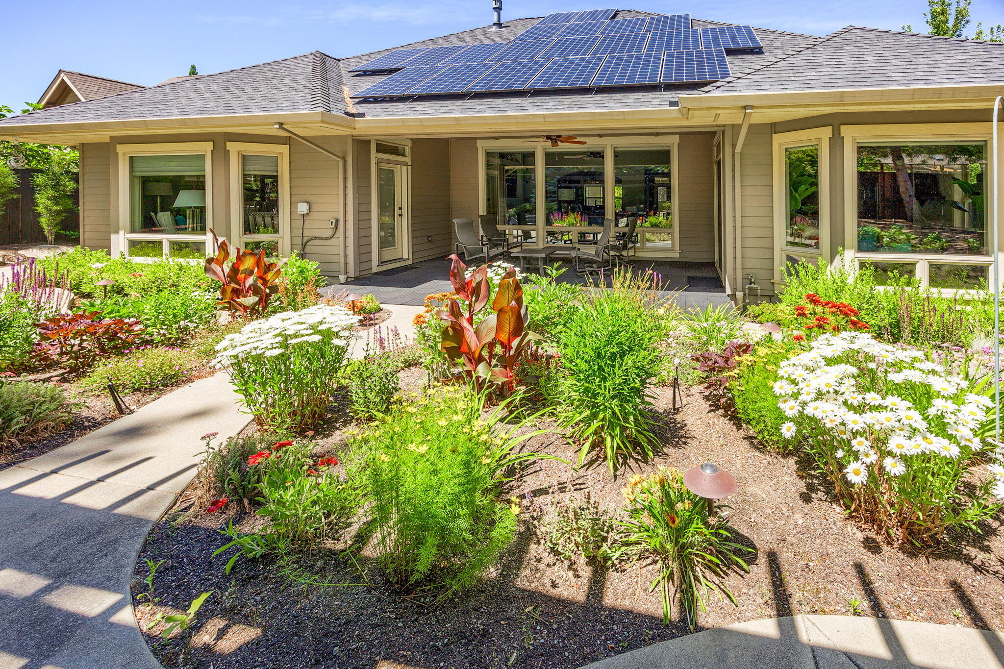 Immaculate, single level home that is sure to please the most discerning buyer! This grand home has beautiful archways & walls of windows throughout. The living room looks out to the peaceful, professionally landscaped backyard w/ hardscape, thoughtful plantings & soothing water feature. The kitchen will make you want to cook! Large island, with plenty of wood cabinets, roomy pantry, quality appliances & stylish hammered copper farm sink. The sizeable primary bedroom has direct patio access. Spa-like bathroom features custom tile work & includes a large walk-in closet. Flexible floorplan with a total of four bedrooms; one currently used as an office with double French doors. Designated Earth Advantage it also has a whole house water filter. Outdoor entertaining is a dream in this home; covered patio with ceiling fan, gas firepit, gazebo, raised garden beds and built in barbeque in the backyard! TID irrigation rights & solar panels. 2 car garage + addtn'l temp controlled 1 car garage.