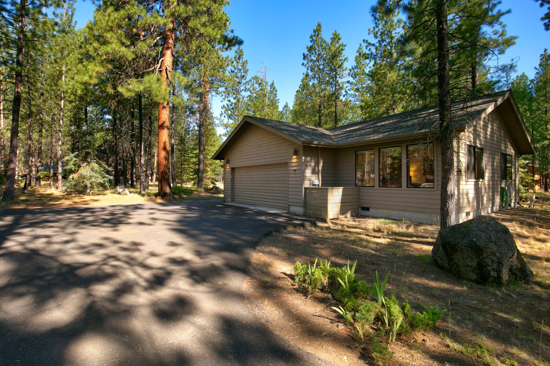 Delightful single-level home nestled in the heart of Black Butte Ranch! This spacious four-bedroom, three-bathroom abode is ideally situated near the Glaze Meadow Recreation Center. Step inside to discover hardwood floors and recently renovated countertops in the kitchen. The inviting great room showcases vaulted ceilings and a cozy wood stove, perfect for relaxing evenings. The primary bedroom boasts a lavish walk-in shower, Japanese soaking tub, tile floors, and a skylit walk-in closet. Additional features include a convenient laundry room with sink, a two-car finished garage, and a newer furnace and heat pump installed in 2023. Step out onto the new deck with railing, offering scenic views of the lush common space. Don't let this opportunity pass you by to make this updated single-level retreat your own in Black Butte Ranch. Schedule your showing today!