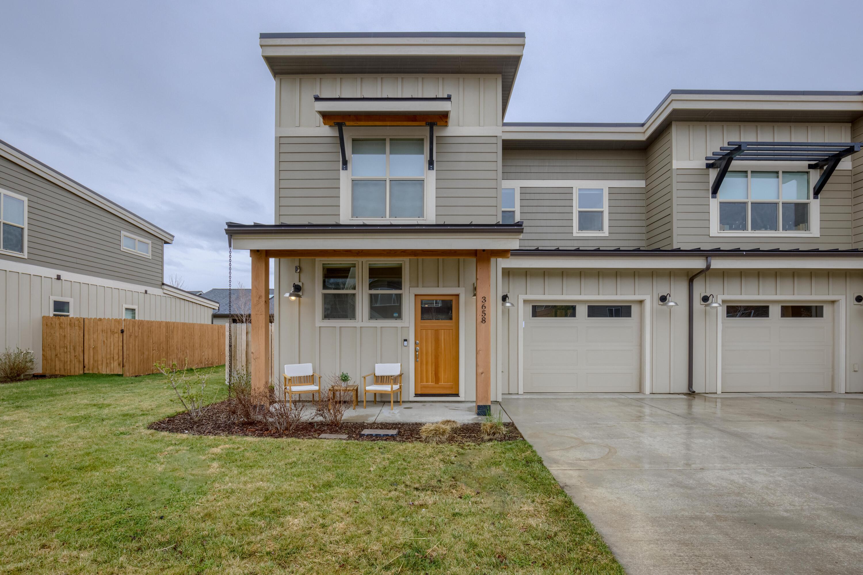 You will find plenty of room in this 1,511 Sq Ft townhome featuring 2 bedrooms and 2.5 bathrooms. Boasting vaulted ceilings for that spacious feel provides a lot of natural light. Located in beautiful Village At Ridgeview near the High School, walking paths and park. Constructed in 2020, this end unit only has one attached wall, private backyard that is fully fenced, and landscaped with patio. Perfect accent of colors, upscale interior with stainless steel appliances, white cabinetry, quartz counters, large windows, fireplace and central air. Single car garage with extra work/storage area, 220 Amp EV plug in option and access to backyard. Less than 30 minutes from Bend, close to downtown, restaurants, shopping and Central Oregon's playground.