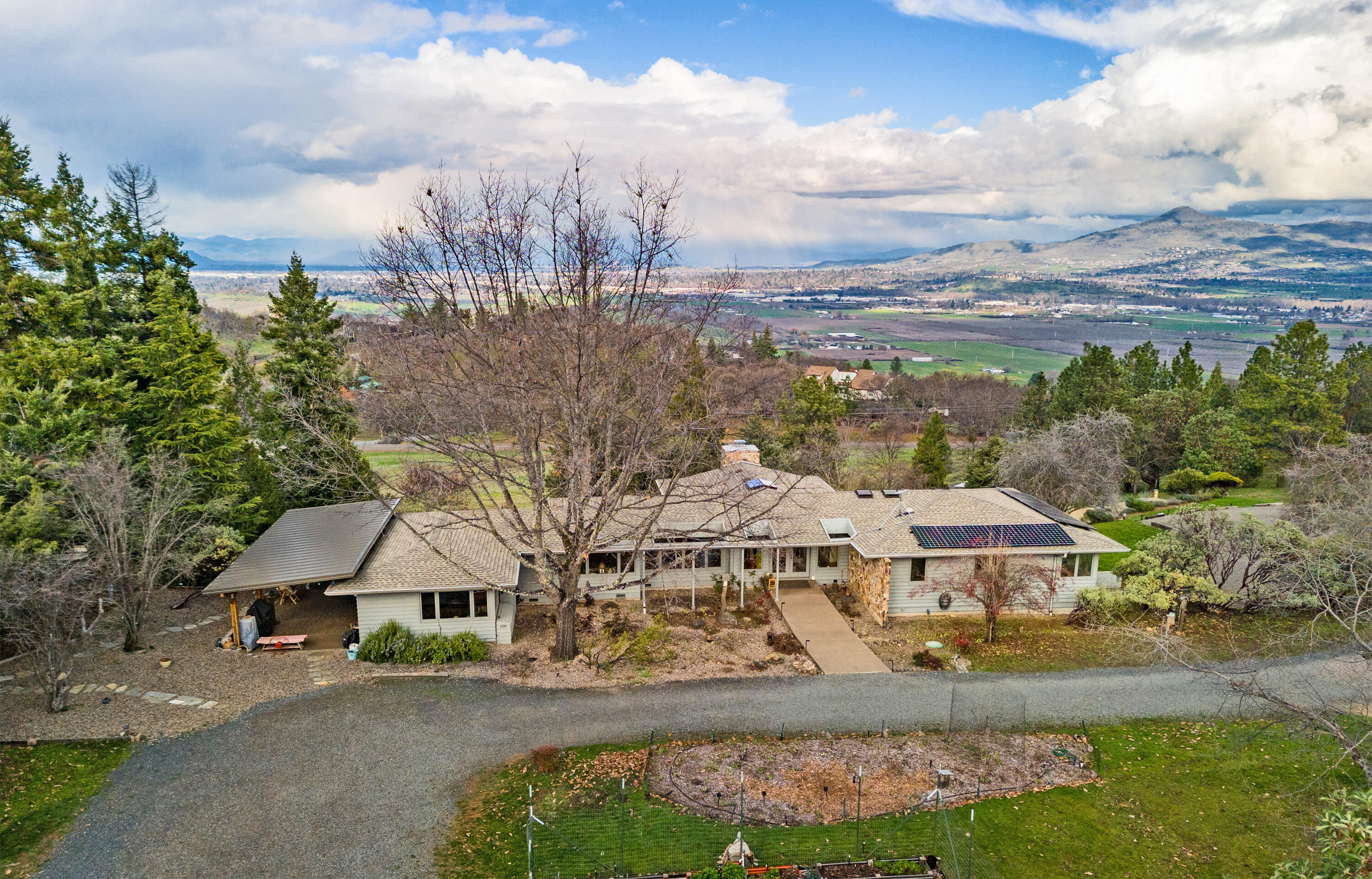 Boasting a stunning 3-bedroom, 2-bathroom residence spanning 3,392 square feet, this architectural masterpiece has a mid-century modern feel. Designed by David Strauss and positioned to enjoy amazing views on 5 acres.
Skylights & large windows bathe the living room in natural light, accentuating the beauty of hardwood floors and an array of modern features. A certified wood stove insert adds charm and warmth, quartz countertops, newer appliances, a washer and dryer, range, hood. 
This property goes beyond the ordinary, showcasing a commitment to sustainability. A 4500-watt solar system powers the essential loads during outages, also ensuring lower power bills from $13.00 - $200. Thousands of gallons of rainwater are harvested through state-of-the-art catchment systems.  An RV garage w/ 60 amp service plus an  underground propane tank and outbuildings for firewood storage. A new roof, HVAC and fresh paint inside and out make this a turn-key home.  Call your Realtor for an Appointment