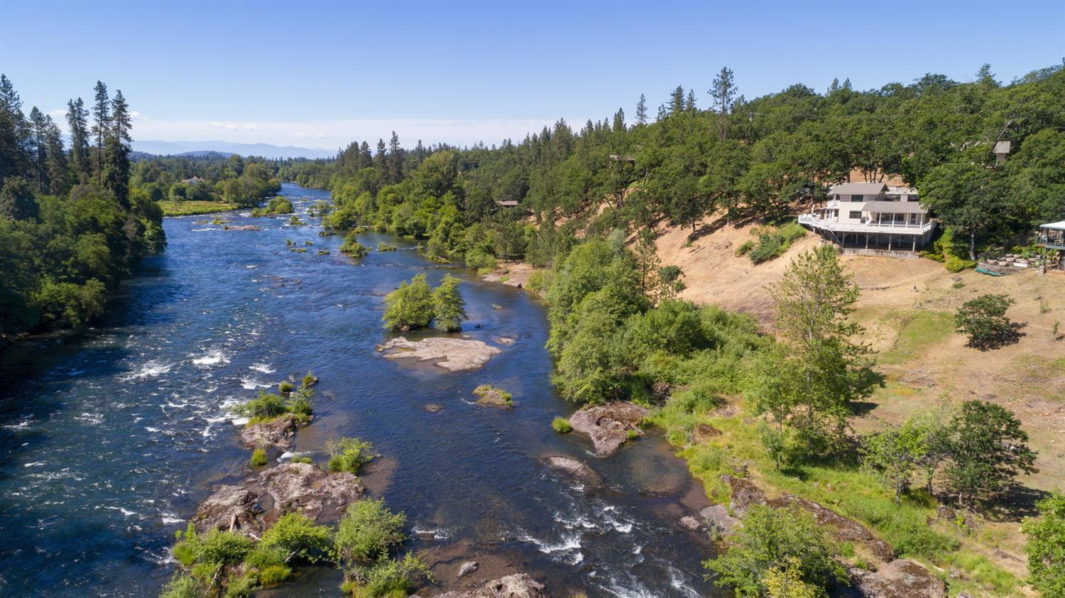 MOTIVATED SELLER - Bring All Offers! One of the most breathtaking Rogue River frontage properties in the area, with sweeping long range vistas from your enormous deck overlooking this world famous river. Over 183-ft of Rogue River frontage. This bi-level home with basement features 3-bedrooms, 2-bathrooms, approx. 1,370 sq. ft. per seller with modern kitchen, tile countertops, formal dining room and big fireplace in living room. Huge detached garage with RV/boat storage. 576 Sq. ft. guest quarters above garage complete with vaulted bedroom/living room and full bathroom. Enjoy world class fishing, rafting and boating.