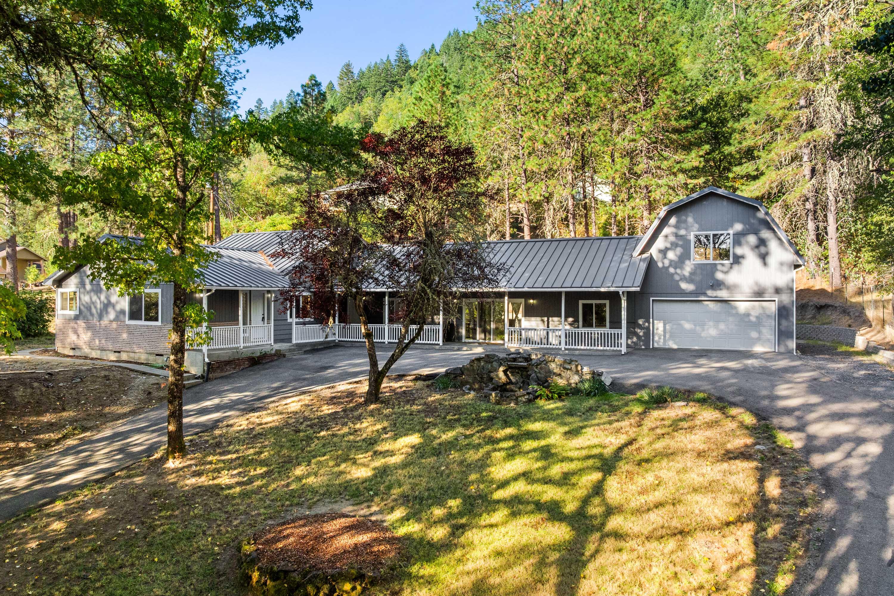 Experience the best of Southern Oregon living in this beautifully reimagined single-story home. With 3 bedrooms, 1 bathroom, and two generous living areas, there's plenty of room for everyday living and entertaining. Modern updates throughout include new appliances, windows, doors, flooring, and fresh paint, all accented by smart LED lighting for a bright, welcoming atmosphere. The heart of the home—the kitchen—features stunning white oak butcher block countertops that add warmth and character, perfectly complementing the fresh, modern finishes. This brand-new renovation has just been completed and has never been occupied, offering that fresh, untouched feeling throughout. Set on a .73-acre lot with a convenient wrap-around driveway, the home is just a short drive—8 miles—to downtown Grants Pass and nearby river access. The upper garage space offers extra storage, making organization easy. Combining modern upgrades with classic country appeal, this newly finished home is ready for you