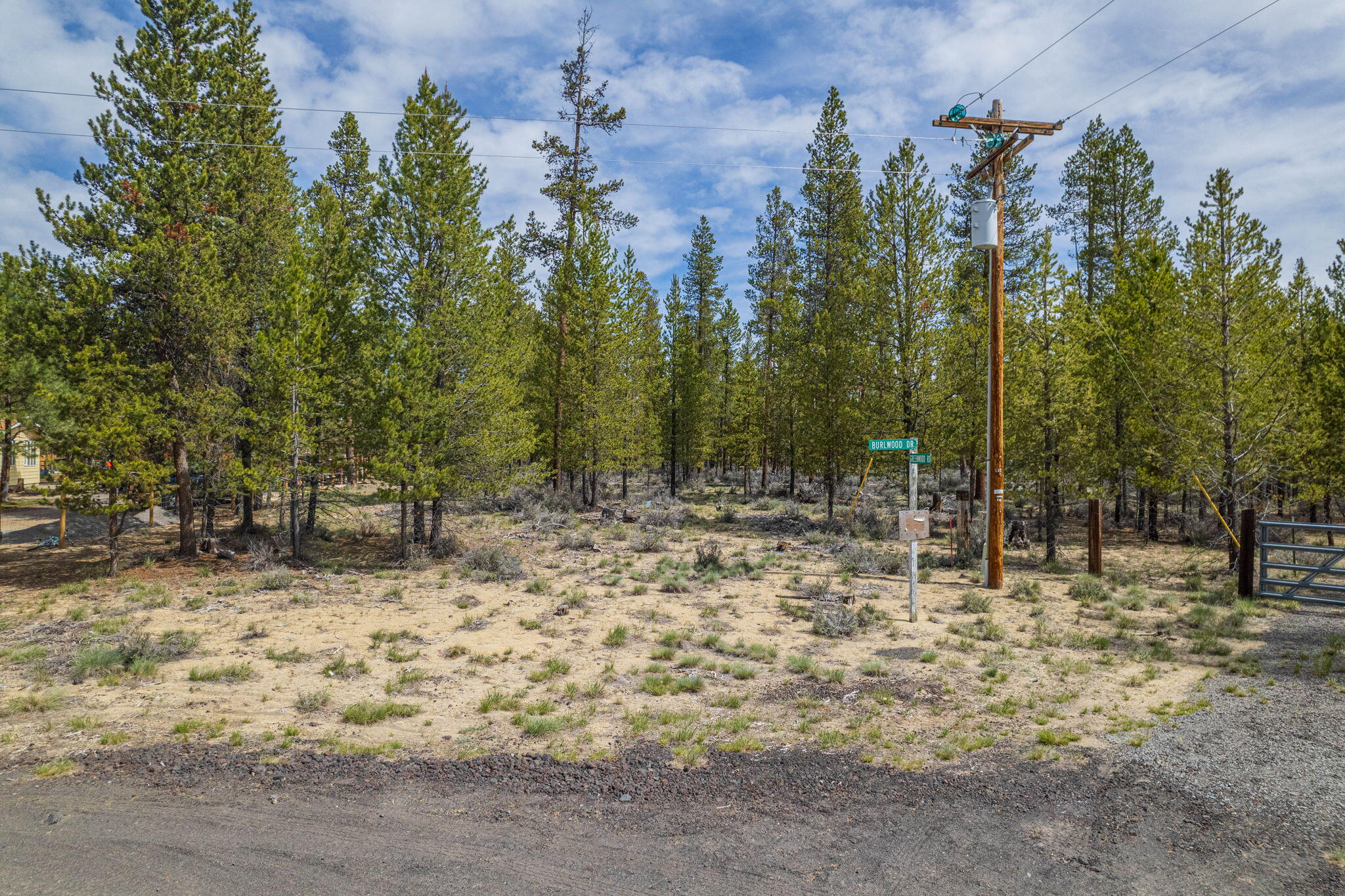 This 1.13 acre lot backs to BLM and is located at the corner of Greenwood and Burlwood in quiet Sun Forest Estates. Level building site that is plentiful with mature pines. Imagine building here and heading right off your property to explore!