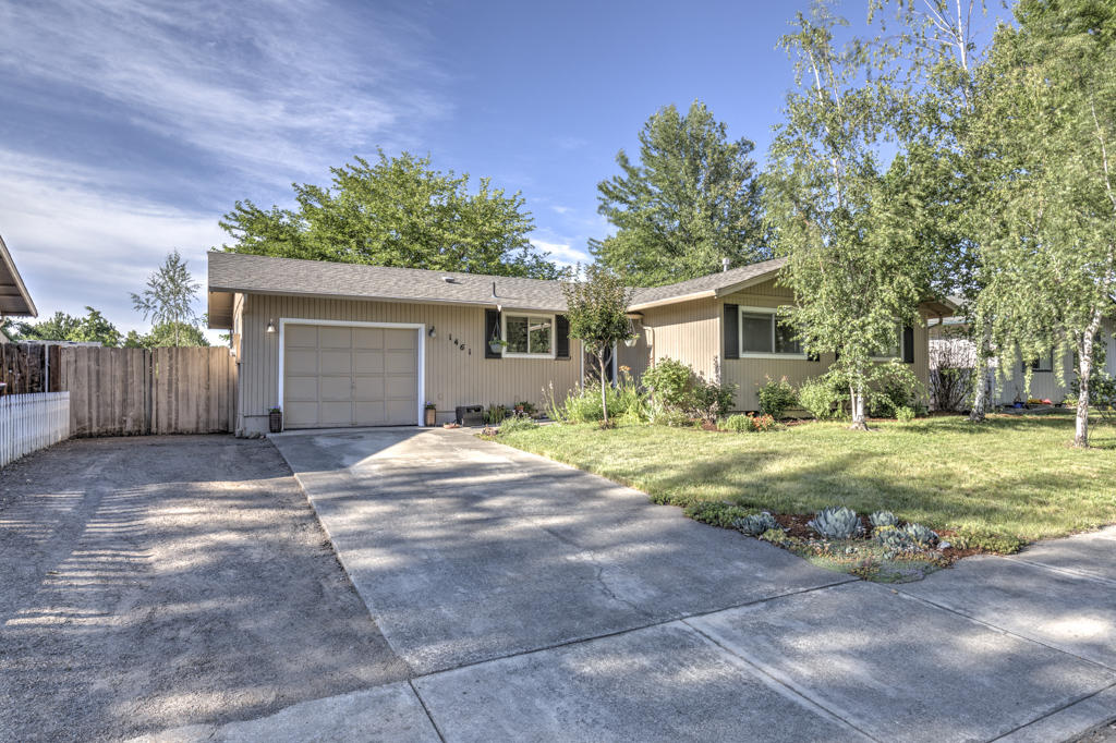 Home Sweet Home!  Lovely East Medford neighborhood perfect for evening walks and family barbecues.  3 bedrooms, 2 bathrooms with an open spacious floor plan.  Kitchen features a wonderful island and stainless appliances.  Back yard is huge and offers mature landscaping with beautiful flowers and an amazing shade tree.  Hot Tub is included.  Space for small rv parking.  This home is move-in ready and waiting for you.
