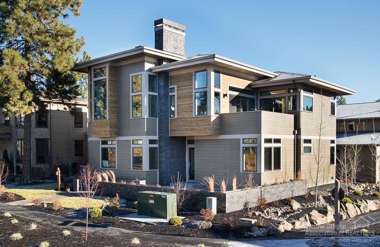 Clean architectural lines meet the warm finishes in the latest Yelas Custom Home in Three Pines. Corner lot on the edge of the development with views across Shevlin Park towards the Cascades. Inverse living floor plan with two upstairs decks and abundant windows. Open plan with generous master and office on the main level. Ground floor features two bedrooms and a bonus room with fireplace and storage closet. Oversized two car garage and mudroom. Access out your door to miles of trails at Shevlin Park!