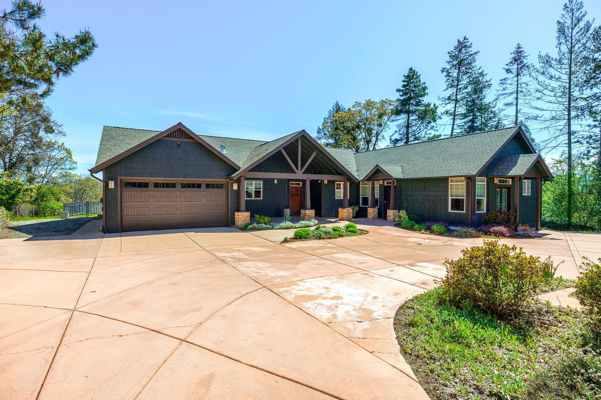 Welcome to the pinnacle of luxury living in Central Point's esteemed West Hills neighborhood. This modern Craftsman masterpiece offers 3022 sq. ft. of refined living space on nearly an acre. With 4 bedrooms, 4.5 baths, and dual 2-car garages (attached and detached with workshop), convenience meets elegance.
Indulge in panoramic views of  Mount McLoughlin and Roxy Ann from the covered patio. The recently remodeled kitchen, a chef's dream, boasts Subzero refrigerator, Wolf stove with griddle, double oven, Cove dishwasher, quartzite countertops and KitchenAid trash compactor. Custom cabinetry elevates the space. Retreat to the primary bedroom, featuring Heated Italian floor tiles, and a copper claw foot soaking tub. Dual shower heads, a bench, and auto sensory night lights create a spa-like ambiance. A unique highlight is the 2-family setup, completed in 2016, with two primary ensuite bathrooms. Seize the opportunity to own this exceptional property.