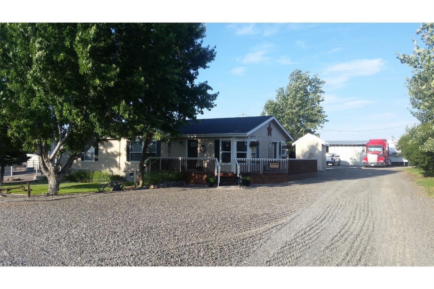 Pride in ownership on this 4.85 acre horse property with 4.4 acres of irrigation. Property is fenced with Shockline Flex Fence hot wire fencing and cross fenced with an arena, tack room, carport and shop area that has concrete floor and power and a storage container behind shop. Inside you will find lot of updates throughout including newer kitchen appliances and a large walk in shower in the master bathroom, nice sized bedrooms and a large living room with views over the property. Additional RV parking at the road has water.