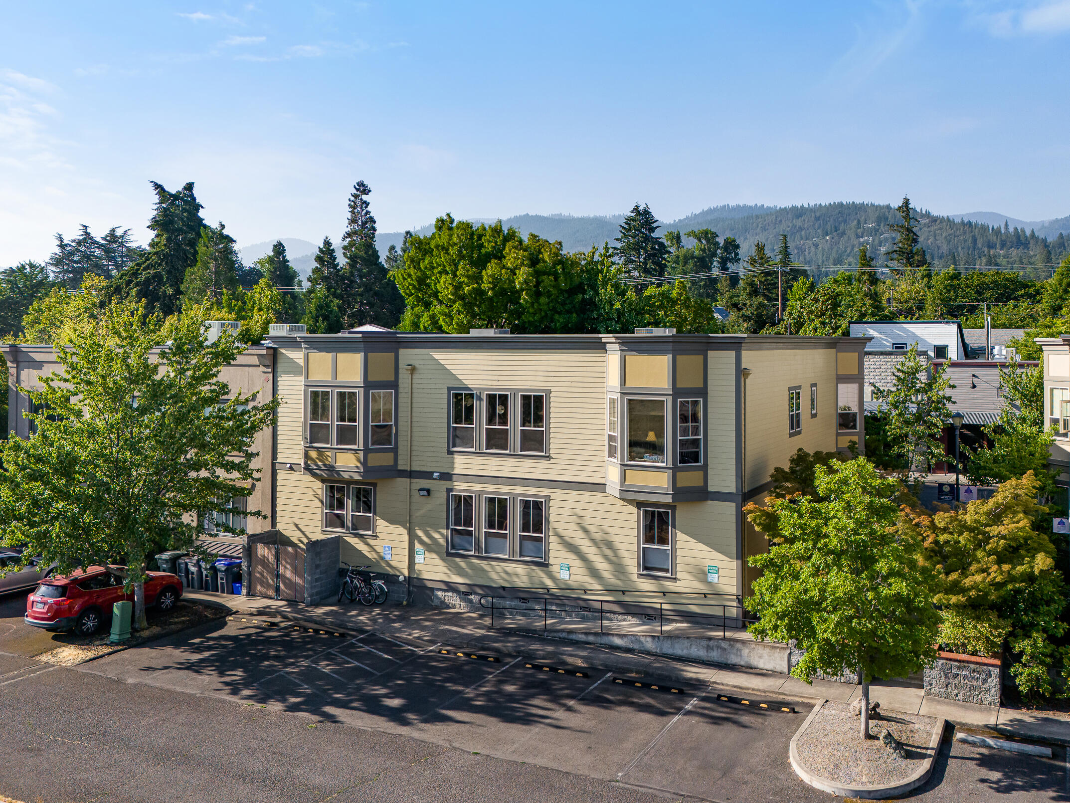 Versatile mixed-use residential and commercial building with strong rental history in the heart of Ashland's historic Railroad District - located near parks, shopping, restaurants, and downtown entertainment. Main level rented by two long-standing commercial tenants occupying three units with multiple entrances from A Street, alley access to Ashland's central bike path, five private parking spaces, and one shared ADA space. Each upper-level residential unit features a spacious living room, kitchen with dining counter and natural gas range oven, one to two bedrooms, full bathrooms, abundant natural light, and mountain views. Property is well maintained and upgraded with low-e windows, fresh exterior paint, new furnaces and AC units, and a new roof within the last ten years. Common area courtyard with mature ornamental trees and plantings. Full due diligence package available - including financials, pro forma, improvements, maintenance records, and floor plans. Inquire for details!