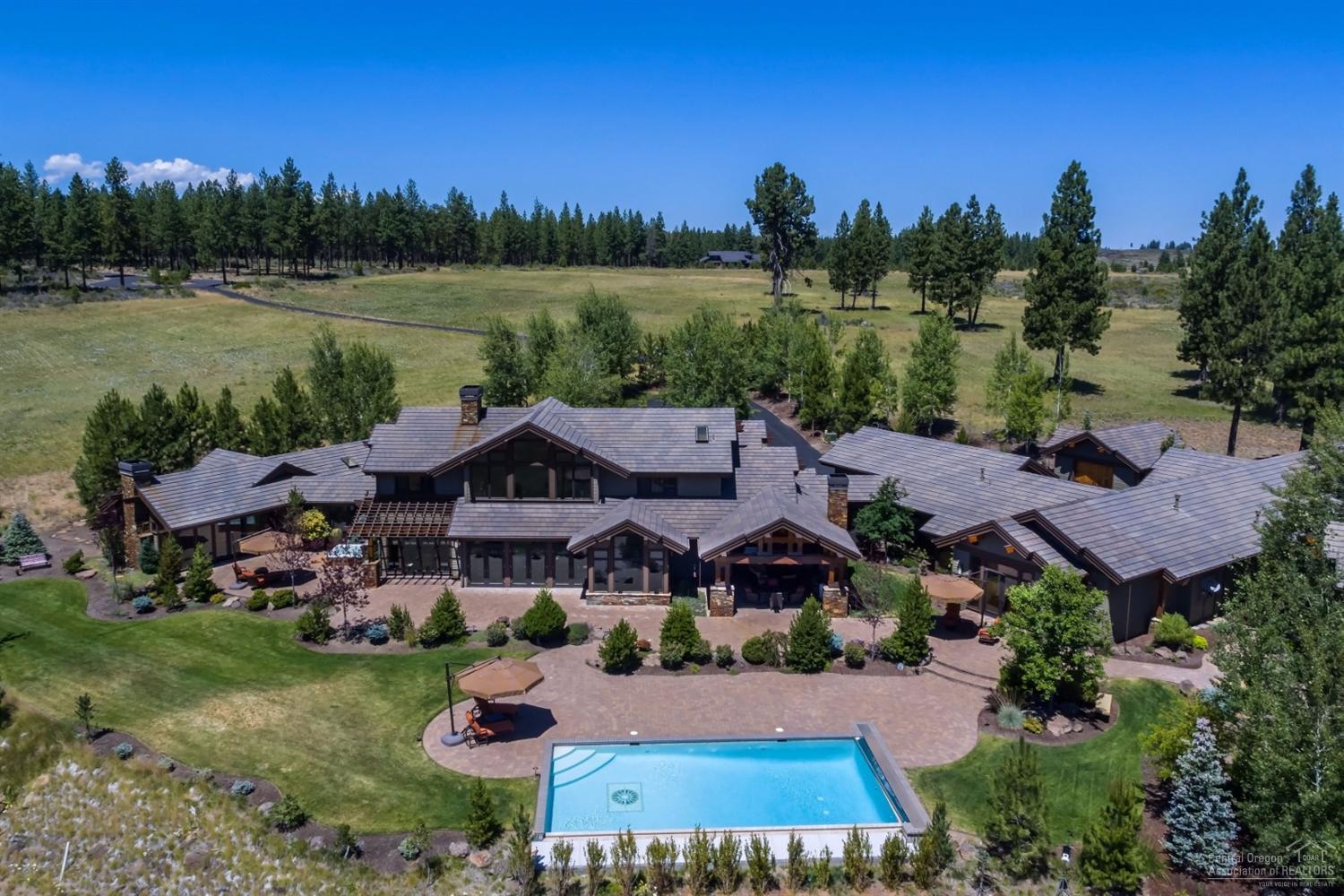 Award winning Norman Building & Design estate in The Highlands at Broken Top. Offers incredible indoor & outdoor living spaces. Phenomenal Kitchen w/slab granite. Cherry wood cabinets w/Sapele wood bar. Great room slate/tile flooring, impressive stone, wood & iron work. Office w/built-in desk & cabinetry. Dramatic main floor master suite, library, 1000 bottle wine cellar, swimming pool, hot tub, theater rm, 1776 guest house, Large room for music, craft or artist studio, 3 garages that hold 9 cars or shop.