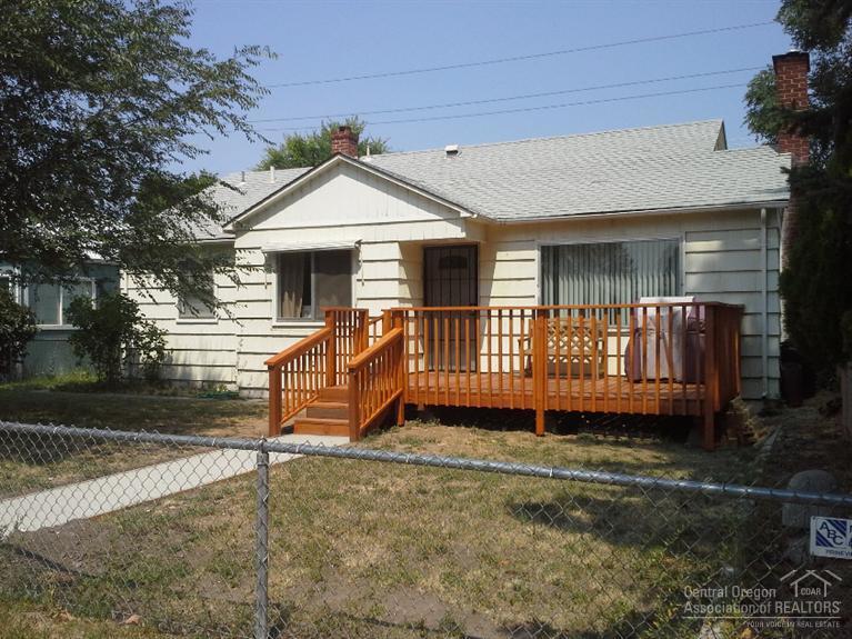 Vintage 3 bedroom, 2 bath home with cyclone fenced yard in town. Double car garage and double carport with access on 6th Street. New natural gas furnace in 2014. Newer kitchen tile. Older original hardwood flooring. Master bedroom has bath. Patio in back, deck in front. New interior paint. New just installed carpet in bedrooms.