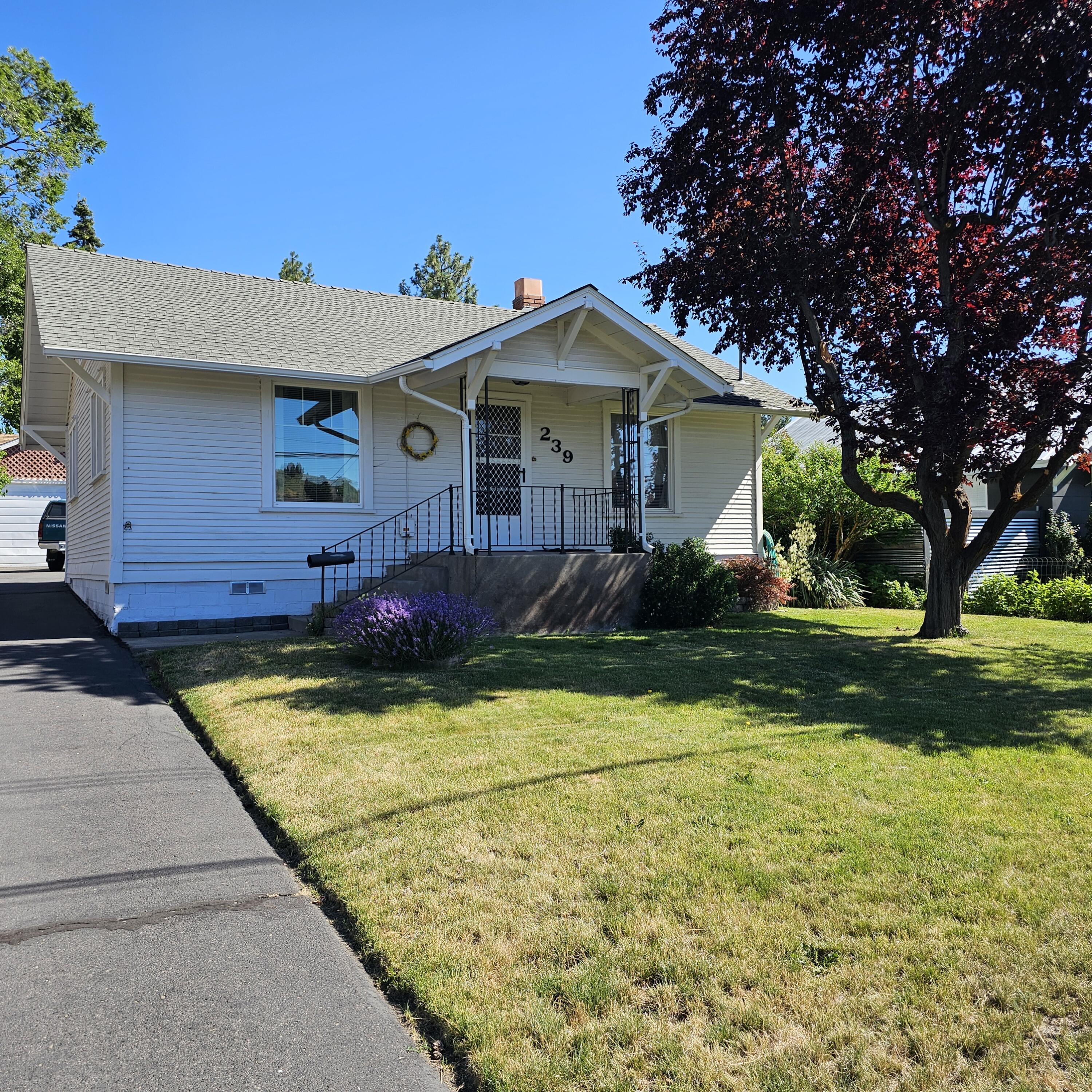 Cozy and well-kept 3-bedroom, 1-bath home featuring a functional kitchen with beautiful oak cabinets and a large laundry room. The master bedroom is privately situated apart from the other two bedrooms. Enjoy a well-manicured yard, asphalt driveway, and detached garage with double bay doors, plus an additional storage shed. A back gate opens to the vacant lot—ideal for adding a shop, extra parking, or RV storage. This property offers charm, functionality, and room to expand!