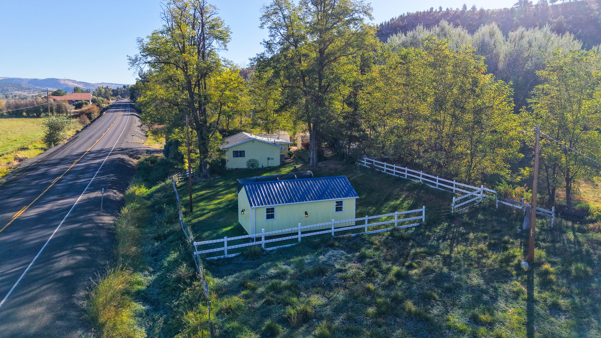 he property spans 1.08 acres and features two fenced pastures with water rights from the ditch. It includes a charming 1900 stick-built residence offering 816 square feet of living space. The kitchen has been updated with hickory cabinets, Formica countertops, and new stainless-steel appliances, all included in the sale. A washer and dryer are also provided. For heating, the home is equipped with a propane furnace, while a swamp cooler and a window AC unit are available for comfort. The flooring throughout the home consists of tile, hardwood, and laminate. Freshly painted interiors enhance the inviting atmosphere. A new tub surround was installed with glass sliding doors.
Additional features include a 7' x 12' shed for extra storage and a 12' x 24' hickory shed with power and some loft storage. The property boasts various plants, including peach, cherry, plum, blueberry, raspberry, and blackberry bushes, as well as ornamental plum, weeping cherry trees, irises, and flaming bushes,