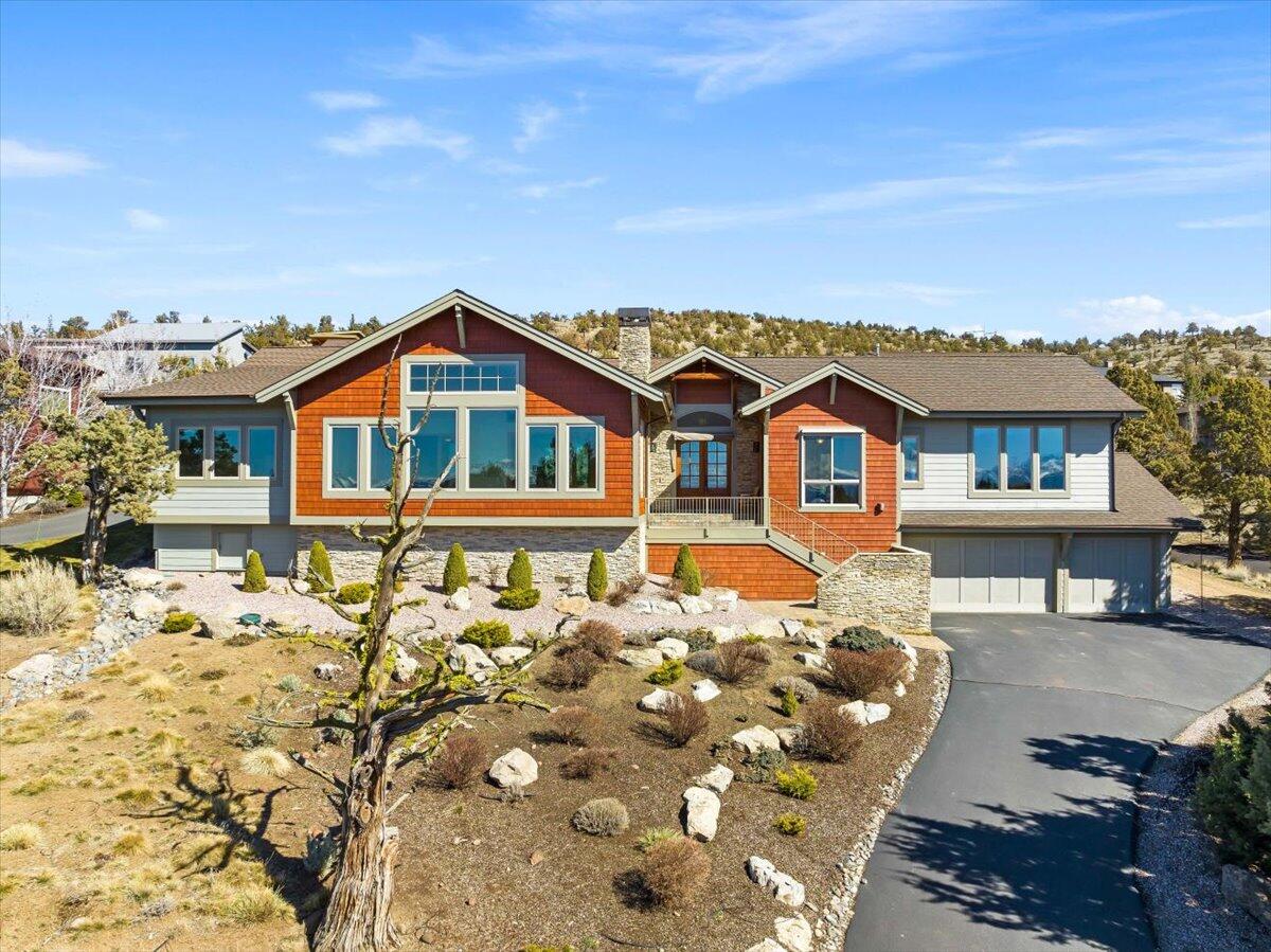 Stunning views of the Cascade Mountains from this beautiful custom home on the West Ridge in Eagle Crest Resort! The great room boasts a vaulted wood ceiling, wood burning fireplace, built-in entertainment center, spacious dining room, and adjoining sunroom to enjoy the panoramic views. Entertain with ease from the well-appointed kitchen with double ovens, gas cooktop, walk-in pantry, stainless appliances and ample cabinetry. The expansive paver patio provides a lovely private space to enjoy a morning cup of coffee or BBQ with the neighbors in the evening. The primary suite will delight you with its own private sunroom, large walk-in closet, ensuite bath with double-sink vanity, walk-in shower, jacuzzi tub, and heated floors. Guest room, full bath, and bonus room with built-ins works as an office, TV room, or additional bedroom. Zoned mini-split heating/cooling for comfort and efficiency. Triple car garage with storage cabinets complete this wonderful Eagle Crest home.
