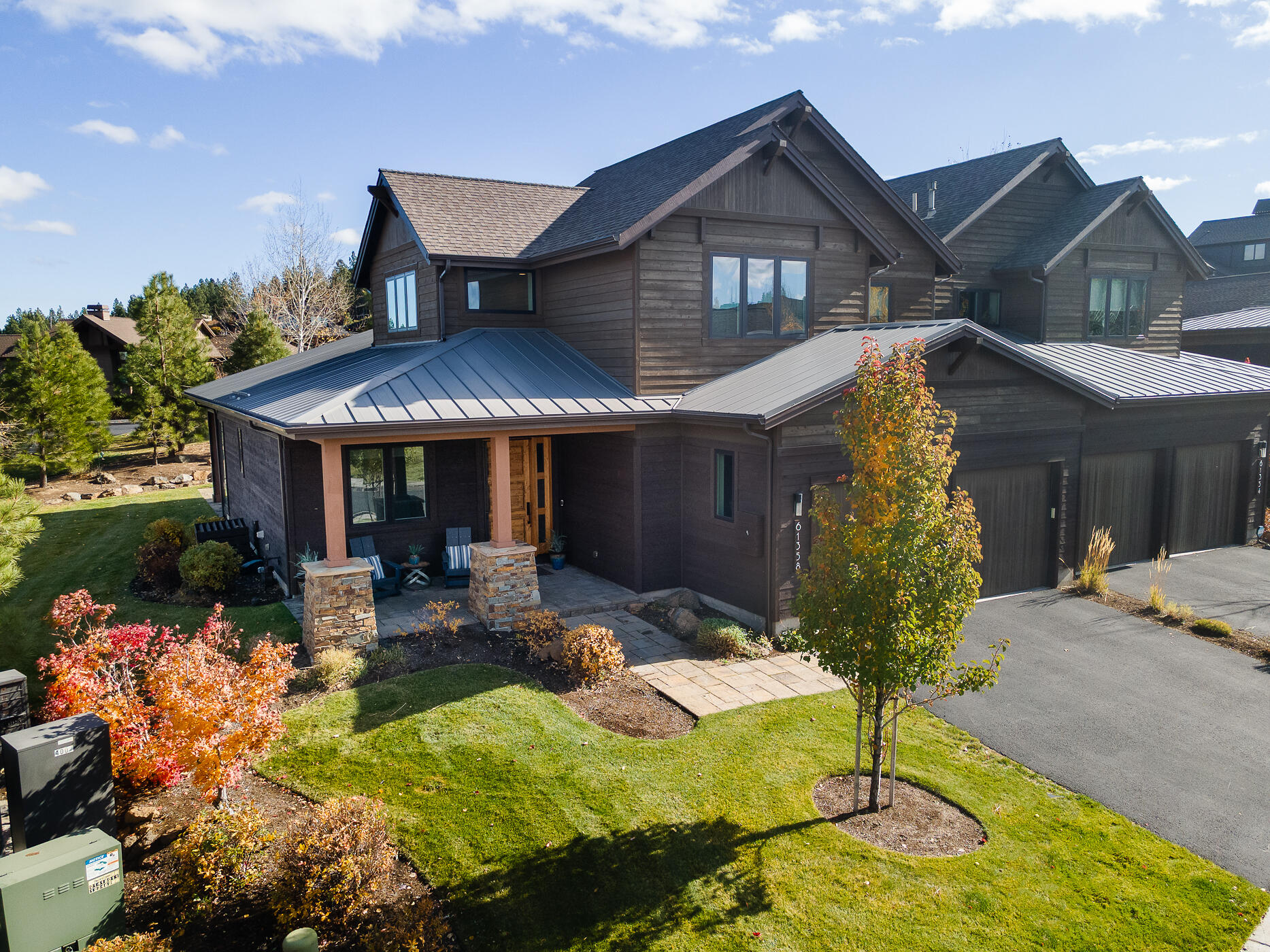 Set on a large corner lot within the exclusive gates of Tetherow, this impeccably maintained Triple Knot townhome offers the perfect blend of luxury, comfort, and convenience. Designed in Northwest contemporary style, the home is filled with natural light and upscale finishes. Features include a main-level primary suite, 2 ensuite bedrooms upstairs, home office, vaulted ceilings, a striking floor-to-ceiling fireplace, hardwood floors, new carpet and paint, and attached 2-car garage. Perfect for entertaining, the gourmet kitchen is outfitted with dual islands, Jenn Air appliances, custom cabinetry, and quartz counters. Enjoy seamless indoor-outdoor living with a covered patio for dining and a Cement Elegance gas firepit for cozy evenings. HOA-managed exterior & landscaping is ideal for a lock-and-leave lifestyle. Tetherow amenities include 2 pools, lap swim, fitness facilities, and social events. Fantastic westside location with easy access to recreation, dining, shopping & more!
