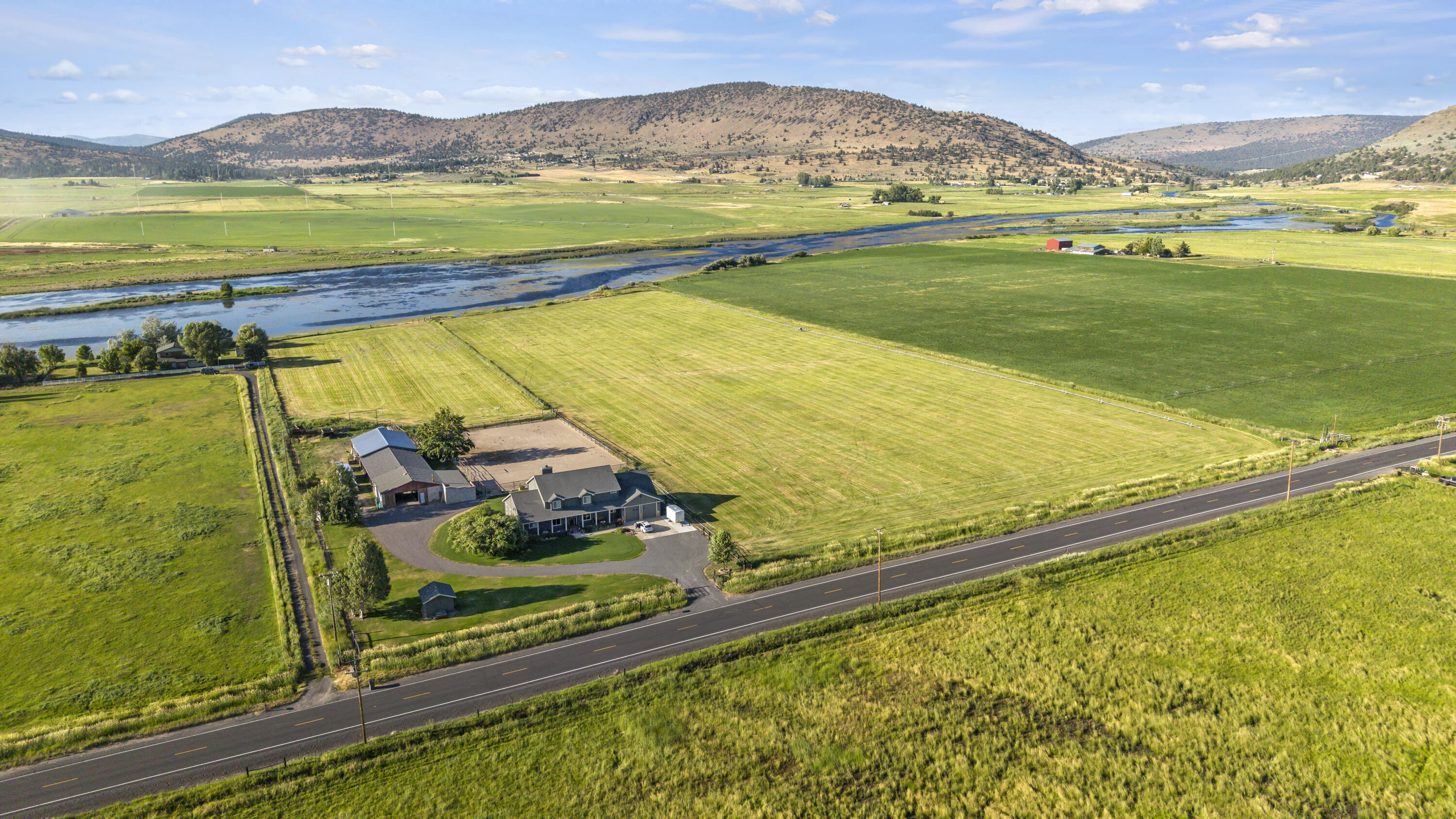 PRICE REDUCTION! Experience the epitome of riverfront living on this exceptional property. Featuring over 15 lush acres of pristine land right on the river, pasture ground, an arena, barn with stalls and tack rooms. The home is magnificent from top to bottom; birch hardwood floors, hickory cabinets, fresh LED lighting throughout, there is even a bonus room, loft and office in addition to the 4 bedrooms. Create your own private oasis on this ranch  with potential for horse enthusiasts, farming, bird hunting, lease out the farm ground, running some cattle or even 4-H & FFA projects. This property is fully set up! Enjoy the A water irrigation with all irrigation equipment is included. There is also a  30x34' shop with additional storage rooms added on. This property is unique in every way, take advantage of this rare opportunity to own a slice of heaven.