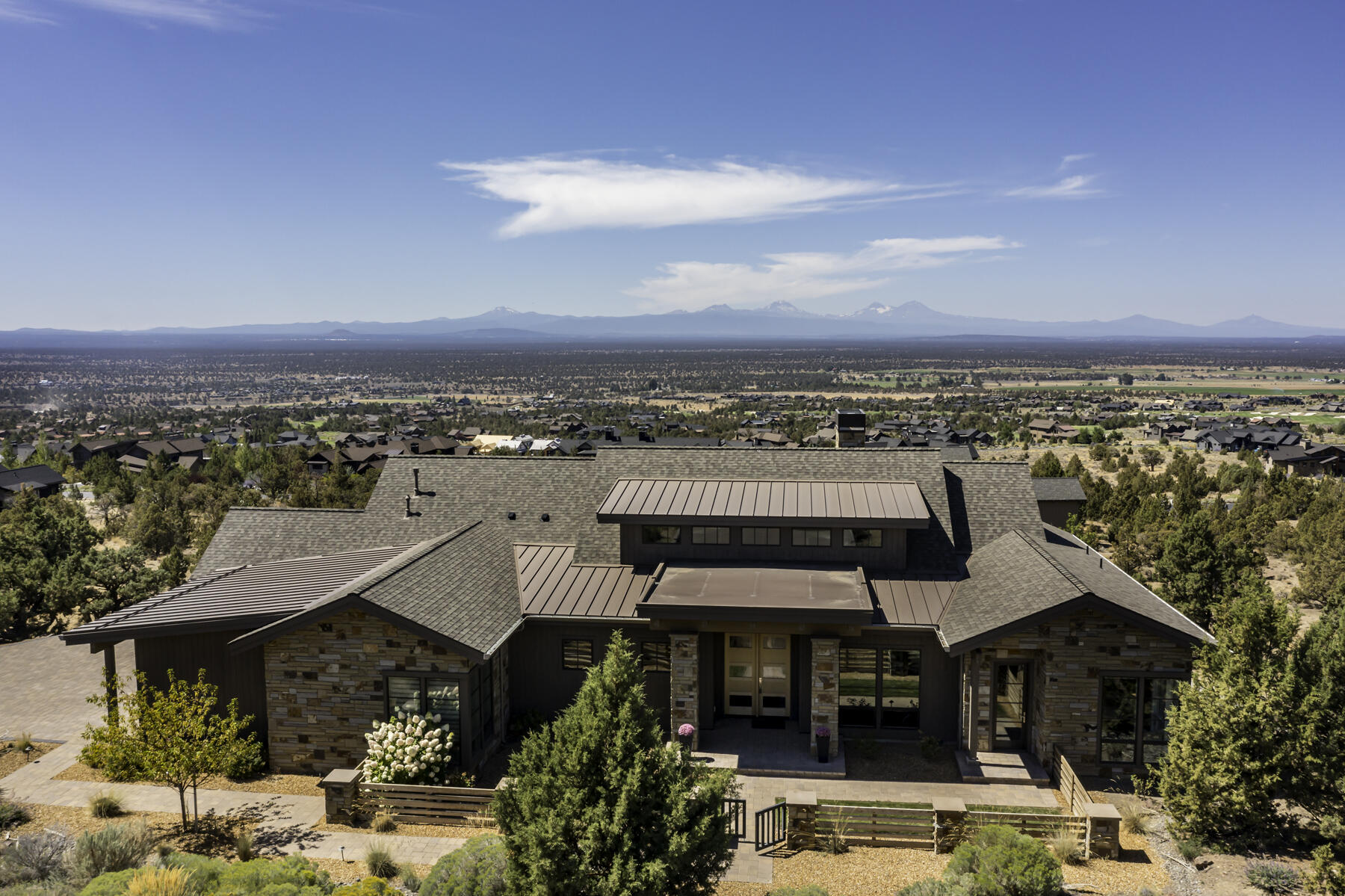 One level living featuring expansive views of the Cascade Mountains. This beautifully designed custom home offers two primary suites separated by a vaulted great room. The 445 square foot attached Casita with private entrance includes kitchenette & walk in closet lives like a luxury hotel room. 3 bedrooms 3.5 baths, 3rd room in main house has Murphy Bed which can be used as a guest room, office or exercise space. Gated pet/mudroom area off 3 car garage entry.  The 12' La Cantina pocket door system creates a seamless indoor/outdoor entertaining experience. The expansive western facing covered deck with automatic sunshades provides a protected space to enjoy a BBQ, stunning sunsets & the mountain views. This home offers a quiet respite in the natural beauty of Central Oregon & Brasada Ranch. Enjoy all the luxury amenities, including golf, athletic center with pools, gym, exercise studio, tennis/pickleball courts, restaurants, spa, general store & miles of bike & walking trails.