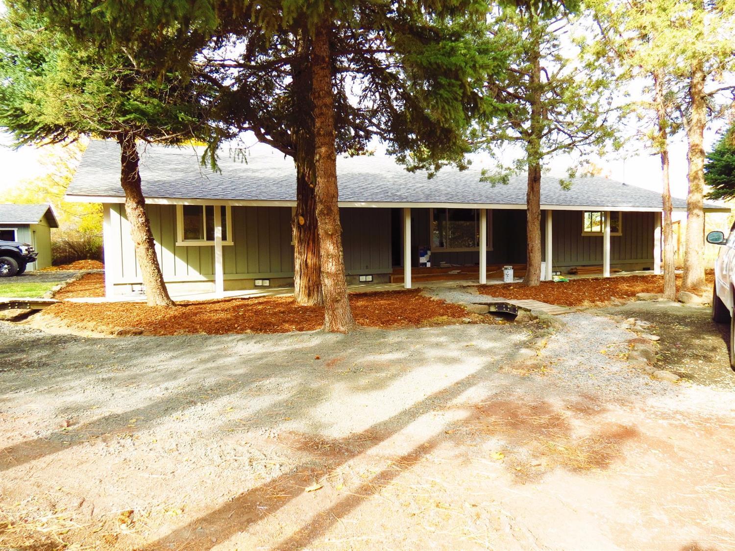 Talk about seclusion this home has it. Sitting at the end of the lane is this 2094 sq.ft. 3 bedroom, 2 bath home that has new laminate flooring, carpet, roof, windows, tiled kitchen counters, large deck, covered entry, master bath with double sinks & tub/shower, stainless appliances, separate garage with new automatic door. Pantry in kitchen. Walk in closet with plus a extra closet in the master bath. Bar in the corner. Pellet stove. Newly painted. Large 0.4349 acre lot with room for the RV's. Move in ready