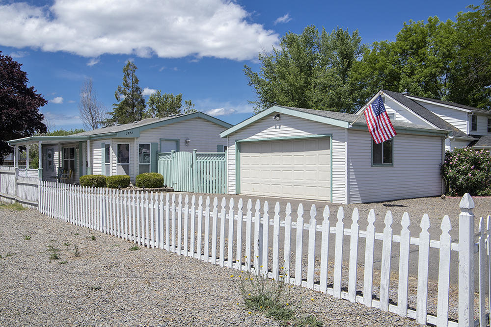 White picket fence curb-appeal w/ low maintenance landscape, this super clean & well maintained 3/2 home on .17/acre lot is a great opportunity for under $300! RV, Boat, or extra vehicle parking area in front. Asphalt driveway, concrete pathways, detached 2 car garage w/ work bench & shelving. Home has a nice covered concrete patio, plum tree, curly willow & great large, fenced back yard. Forced heating & air recently serviced, vaulted ceilings throughout, 3 bedrooms w/ split bedroom plan for privacy and each w/ its own walk-in closet! 2 full bathrooms! Kitchen offers great lighting w/ breakfast nook in rounded garden window & skylights, Fridge, range/oven, microwave & a new pull-out faucet in sink, open pass thru to living room. Solid concrete block perimeter foundation w/ a large crawlspace w/ vapor barrier. Pest contract in place for one year. Roof is newer (last 10 years). Furnishings are negotiable or happily included. Home Warranty!