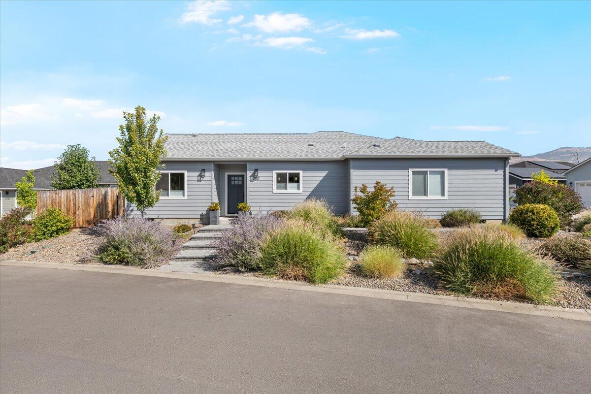 Back on the Market! No Fault of the property. Welcome to this beautifully maintained home on a large lot in the highly desirable Oak Valley 55+ community in Talent. Featuring an inviting open-concept layout with vaulted ceilings & a cozy fireplace, this home is designed for comfort & style. The kitchen showcases quartz countertops, while the bathrooms are elegantly finished with marble. A thoughtful split-bedroom floor plan offers privacy, with the primary and ensuite bathroom separated from the guest bedroom and office/third bedroom. The professionally landscaped backyard includes automated drip irrigation & an oversized concrete patio, perfect for entertaining or quiet evenings. An extended driveway & extra backyard gate provide added functionality & convenience. Nestled in a peaceful setting with nearby walking trails, pond, club house & pool, this home blends charm, walkability to downtown Talent & the best of Southern Oregon's active adult lifestyle.