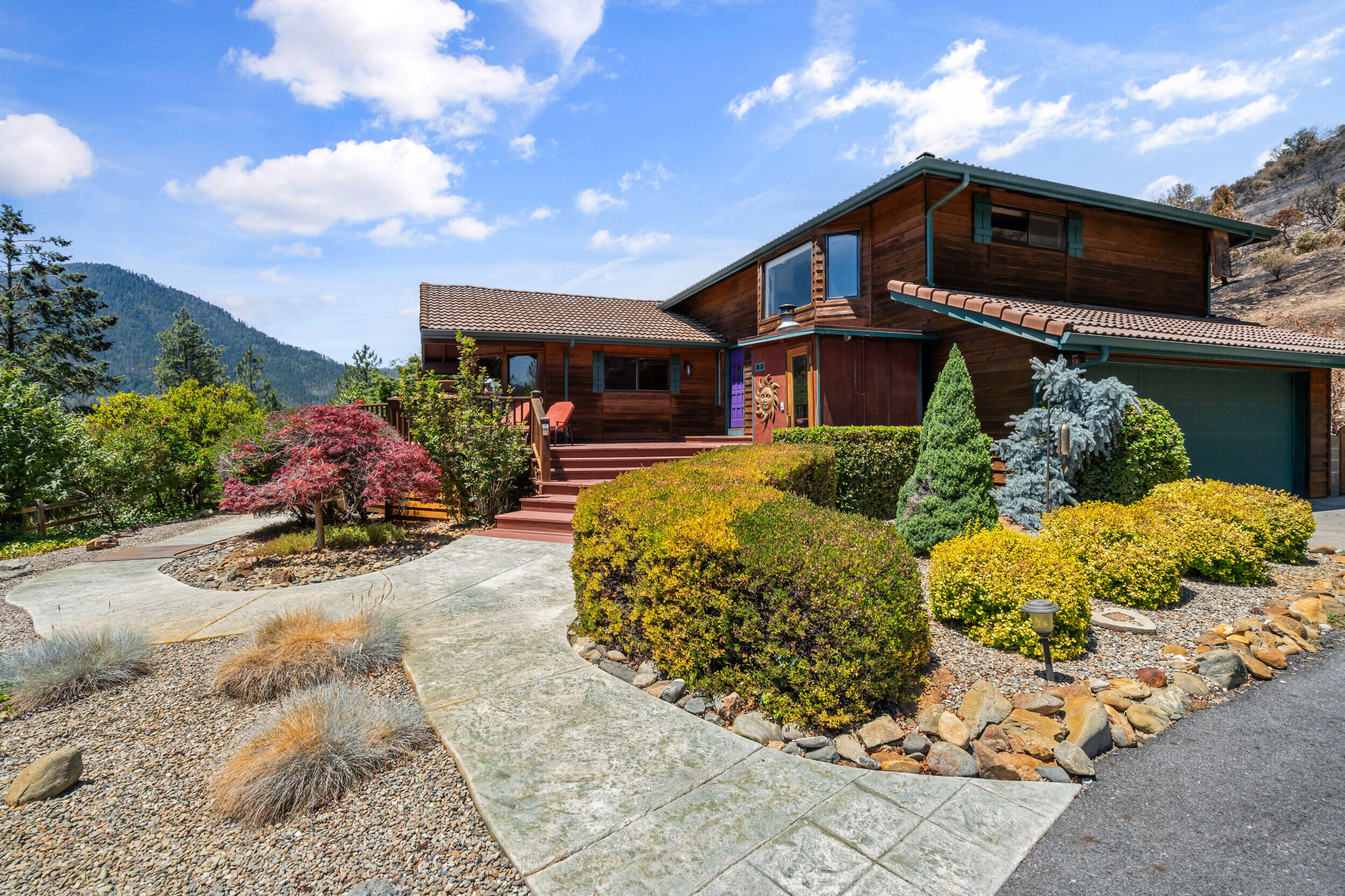 PRICED TO SELL! Beautiful 5-acre Jacksonville retreat.
Private paved drive leads to a 3-bed, 2.5-bath, 2,124 sqft cedar-sided home with wraparound deck and sweeping Applegate Valley views. Property includes BLM land behind, a professional grade pickleball court with covered patio, plus a small workshop and sauna. Inside features a wall of view windows, updated kitchen with stainless appliances and granite island, and a master suite with bay window, walk-in closet, and dual-sink bath. Also includes a versatile mother-in-law unit and a 2-car garage with storage. A rare, private getaway—schedule a tour today!