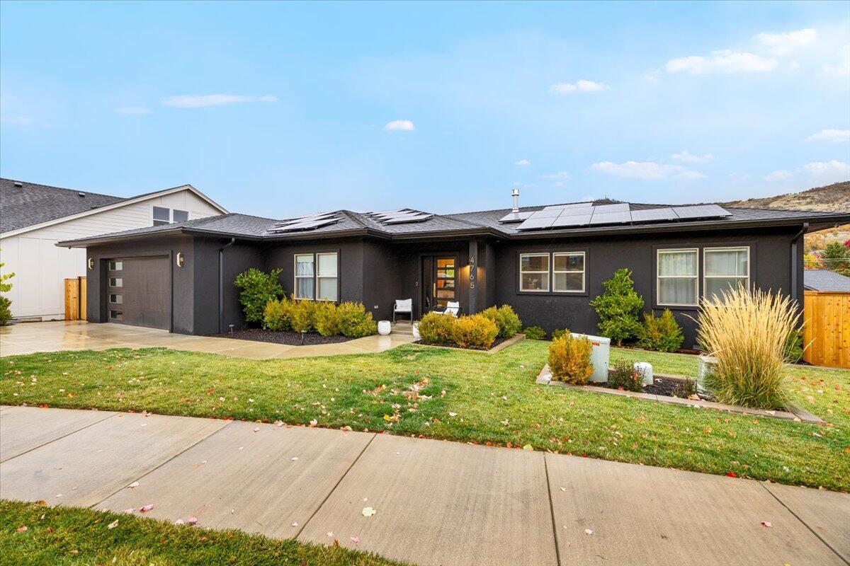 Welcome to this beautifully maintained 3-bedroom, 3-bath home in highly desirable East Medford! Built in 2020, this 2,610 sq. ft. home offers modern comfort and thoughtful design throughout. The open floor plan features a spacious living area with a cozy gas fireplace, ideal for entertaining or relaxing. The kitchen flows seamlessly into the dining and living areas, while a downstairs bonus room provides flexibility for an office, gym, or guest space. You'll enjoy two private balconies, perfect for morning coffee or evening sunsets. The primary bedroom offers a luxurious ensuite with a soaking tub, walk-in shower, and ample storage. Step into energy savings with fully paid-off solar panels and the convenience of a 2-car garage and a finished storage room, all on a spacious lot. Don't miss this move-in ready home in one of East Medford's most desirable neighborhoods!