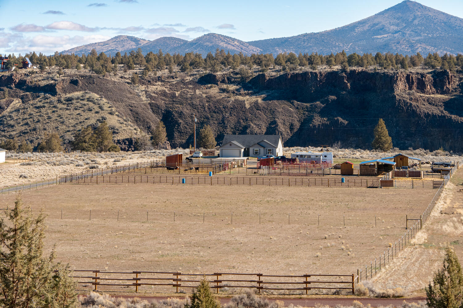 Don't miss your opportunity to own 10+ acres on the river at the edge of Crooked River Ranch! Beautifully maintained like new home ftrs a great room floorplan w/ vaulted ceilings & tons of windows for an abundance of natural light throughout! Kitchen ftrs large island w/ breakfast bar seating, plenty of prep & cabinet space, large walk-in pantry w/ built-in shelving, & spacious eating area. Large primary suite ftrs walk-in closet, private bath w/ dual vanities, & enclosed toilet area. Two add'l bedrooms share a full bath. Office/den w/ french doors or use it as a fourth bedroom. Oversized mud room & dual car garage. Crooked River is right out the back door! Outside you'll find: an arena 120' x200' with roping chute (option), 55' round pen, 8x12 tack room, 10x20 barn with two 10x20 attached equipment lean to's. 24x30, 20 ton hay barn. 2 double horse shelters with 4 horse pens. 2 cattle holding pens. Plus 2 fully fenced dry lots. Optional access to all CRR amenities! Live & play here!