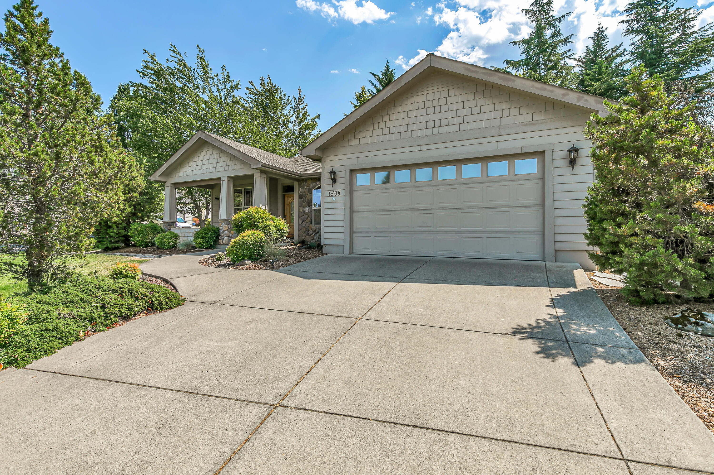 Beautifully maintained single-level home located on the corner lot of a cul-de-sac within the Lone Pine school district. Step inside through the covered front porch and gallery style entryway into the first living area, where you can enjoy sunset views of Roxy Ann while cozied up next to your gas fireplace. The kitchen has granite countertops, a stainless-steel chef's sink and updated Kenmore elite appliances. Enjoy meals at the breakfast bar, or in the formal dining room. The main living room offers another gas fireplace as well as a 65'' Samsung picture frame television. Access the backyard through sliding glass doors in the living room or primary bedroom. The yard is low maintenance, with synthetic lawn and a sprinkler system for the established landscaping. It is fully fenced and private. The large, covered patio has hookups for a gas BBQ, string lights and ceiling fans- perfect for entertaining!
