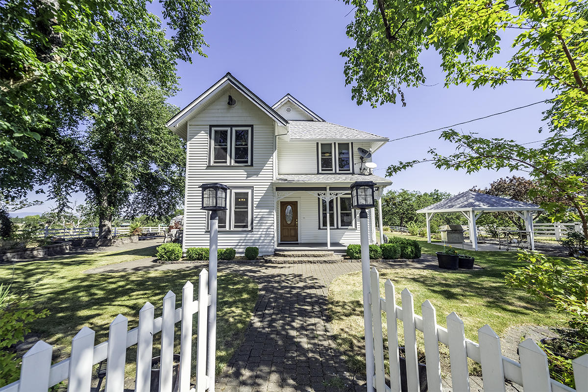 2 homes on over 55+ EFU acres with 35 irrigated for this storybook setting of mature trees including 4 Siberian Elms, lawn areas, stone walkways & vast views. Circa 1900 built gracious Farm House with original ornate woodwork. Spacious rooms, large windows & views in all directions. Covered porch leads to living room which opens to large family room, formal dining & large kitchen. The kitchen has Corian counters, stainless appliances, island, 2 built-in buffets & sizable informal dining. Separate office & full bath plus laundry on main level. Upper-level features 4 bedrooms & 2 baths. 3 car garage for main house, huge 1488 sf shop, RV covered parking, play area, large paver patio & 13 planter beds. 2nd residence at 499 Meridian has a darling ranch style home with 2 bedrooms, newer quality laminate flooring, cute kitchen with dining, remodeled bath, covered gazebo, pastures, 2021 built 4 car garage, 25x30 shop with 110 & 220. Both homes are on one tax lot. This is a fantastic property!