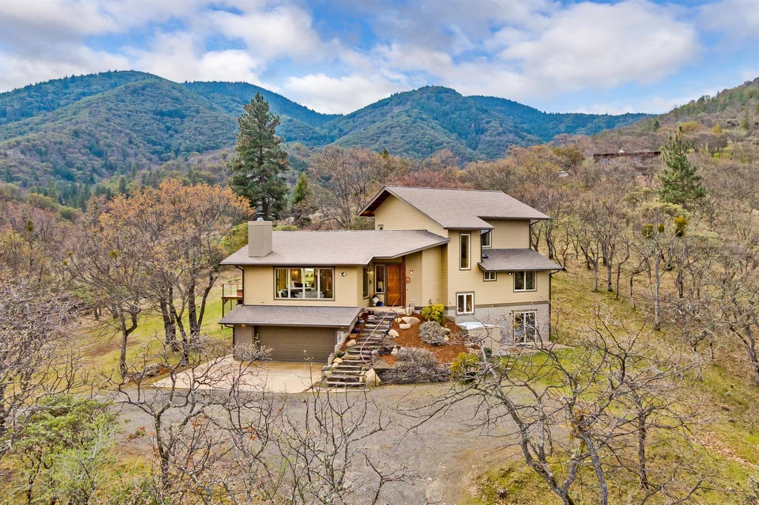 Elegant home on 20 acres 5 minutes from Ashland's plaza. Experience solitude in this wooded sanctuary with views of nature from every room. Natural light floods the open floor plan & the vaulted ceilings create a spacious living experience. ICF Blue Maxx exterior walls, 2.5 KW of PV & a geothermal heat pump provide energy conservation. Natural materials used throughout; oak, bamboo, concrete & tile floors, knotty pine ceilings, birch doors & trim and concrete countertops. The kitchen features a 4 burner 36'' gas range with grill & natural wood block island. Master suite includes 2 lg. walk-in closets & wool carpet. The master bath has a jetted tub & 2 head shower set in stunning tile work. The main level living area offers 2 bedrooms & a full bath. Lower level features a bedroom with 1/2 bath, full sauna & and outdoor shower. The home features an oversized garage, a central vac system, a wood FP & a large ipe hardwood deck with a perfectly placed hot tub for enjoying the views.