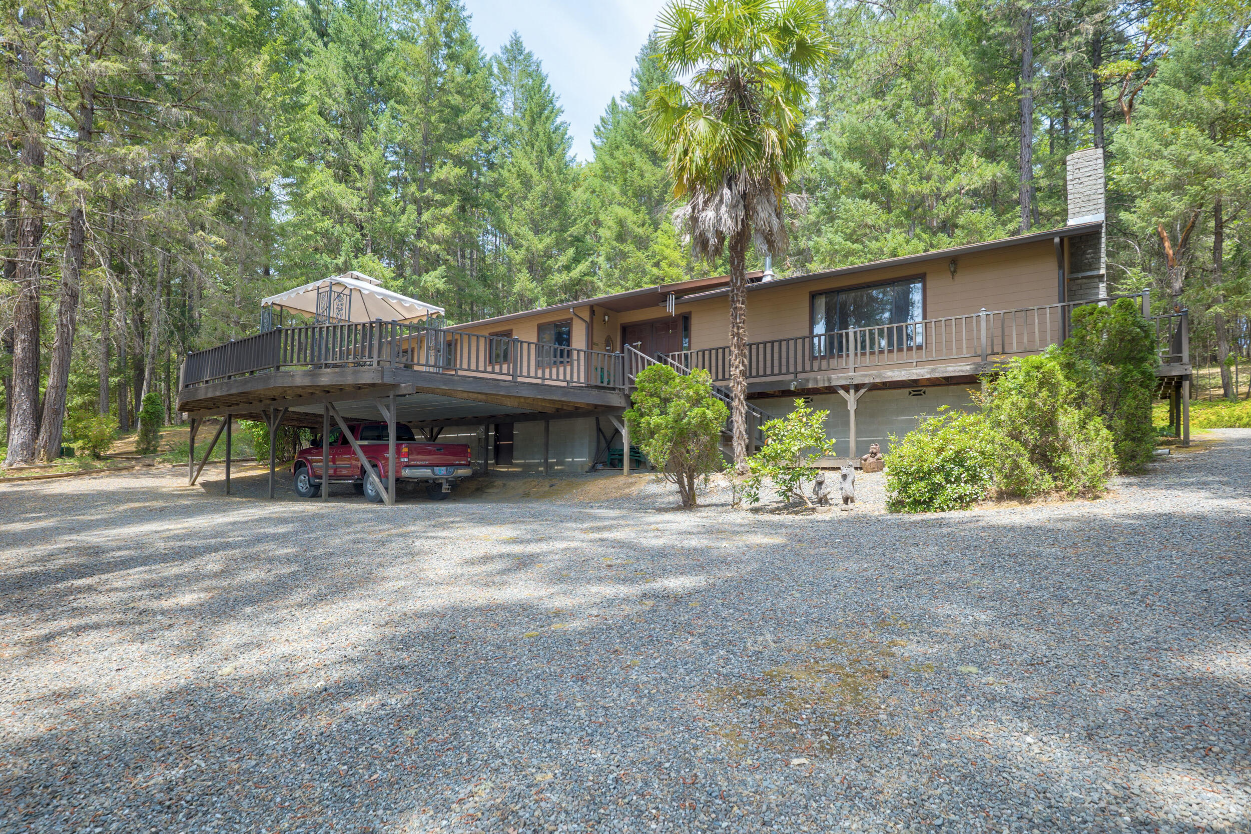 Welcome to this exceptional first-time-on-the-market property offering comfort, space, and rural beauty. This 2,308 sq ft home features 3 bedrooms and 2 full baths on 11.79 picturesque acres, perfect for country living. The spacious kitchen offers ample storage, an island, and a cozy breakfast nook. Enjoy the warmth of woodstoves and a large picture window with stunning views. An additional family room provides space to relax or entertain. The primary bedroom includes an en suite bath and sliding doors to a large deck. Fully fenced and cross-fenced, the land is ideal for horses, livestock, or farming. A seasonal creek adds charm. Outside, there's a large insulated shop with RV parking and stables—great for equestrian or hobby farm use. A new roof was installed in 2015. Whether you're seeking a peaceful retreat, a hobby farm, or a full-time residence with room to roam, don't miss this rare opportunity to own a slice of countryside paradise.
