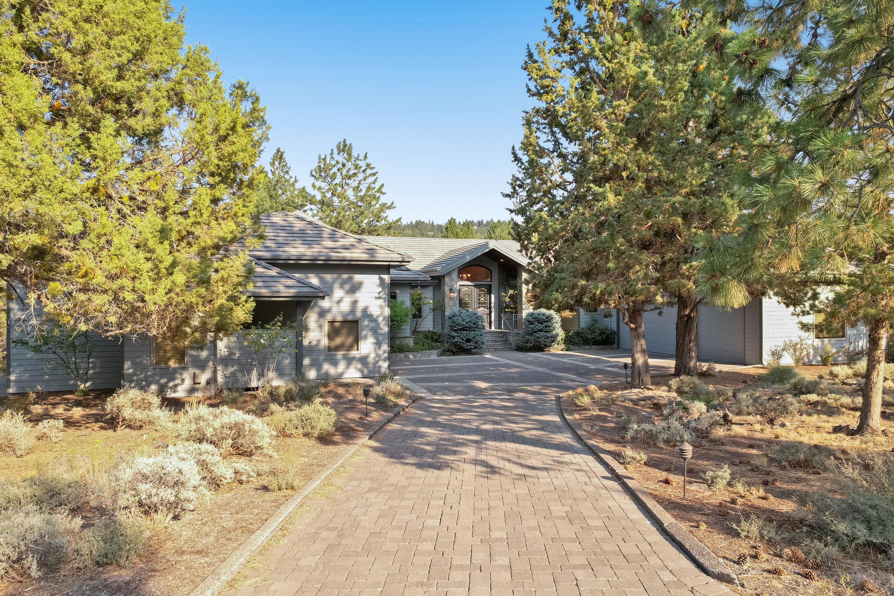 Room for everyone. Thoughtfully designed Northwest style home in Awbrey Glen overlooking the 11th green. Easy living floor plan featuring a welcoming entry, dining, great room with vaulted ceilings and wonderful natural light. Beautiful kitchen with slab granite counters, abundant counter space, 6-burner gas cook top, double wall ovens, warming drawer, built in refrigerator, large pantry and kitchen nook. Primary suite with fireplace, walk-in closet, double sinks w/ separate vanities, tile shower, and soaking tub. Private guest wing with 2 spacious bedrooms and full bath. Utility room with built-in cabinets/desk area leads you to the attached 3-car garage PLUS an 800 SF drive-thru RV Garage. Downstairs is an additional 1699 sq ft daylight basement/bonus room with office/4th rm, full bath and tons of storage. Radiant floor heat and solar panels makes this house super efficient and comfortable all year round.