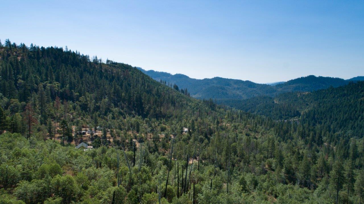 Here is a wonderful opportunity for many uses. This 32.5 property has over 4000 acres of BLM around it, so the views are unmatched. The road is well established up to the property,and the privacy and seclusion are great. The property is well established, several areas of cleared land for gardening & recreation. There is a fantastic well per the seller with a couple above ground holding tanks. Lots of sunlight, wildlife and endless opportunity. There are a few out buildings/storage sheds, established RV/Camper areas, and even an old hunting cabin to facilitate any of your recreational desires. The property is just a few minutes from Lost Creek Lake and just down the road from the world famous Rogue River.